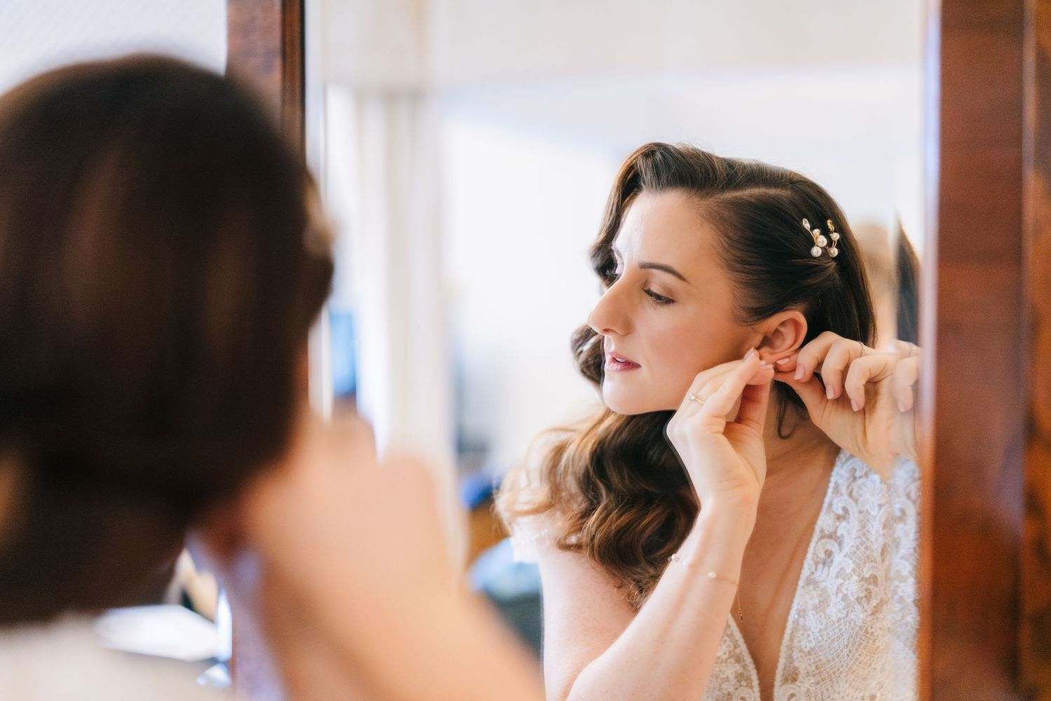 Close-up shots of wedding preparation showing delicate makeup application and styling details.