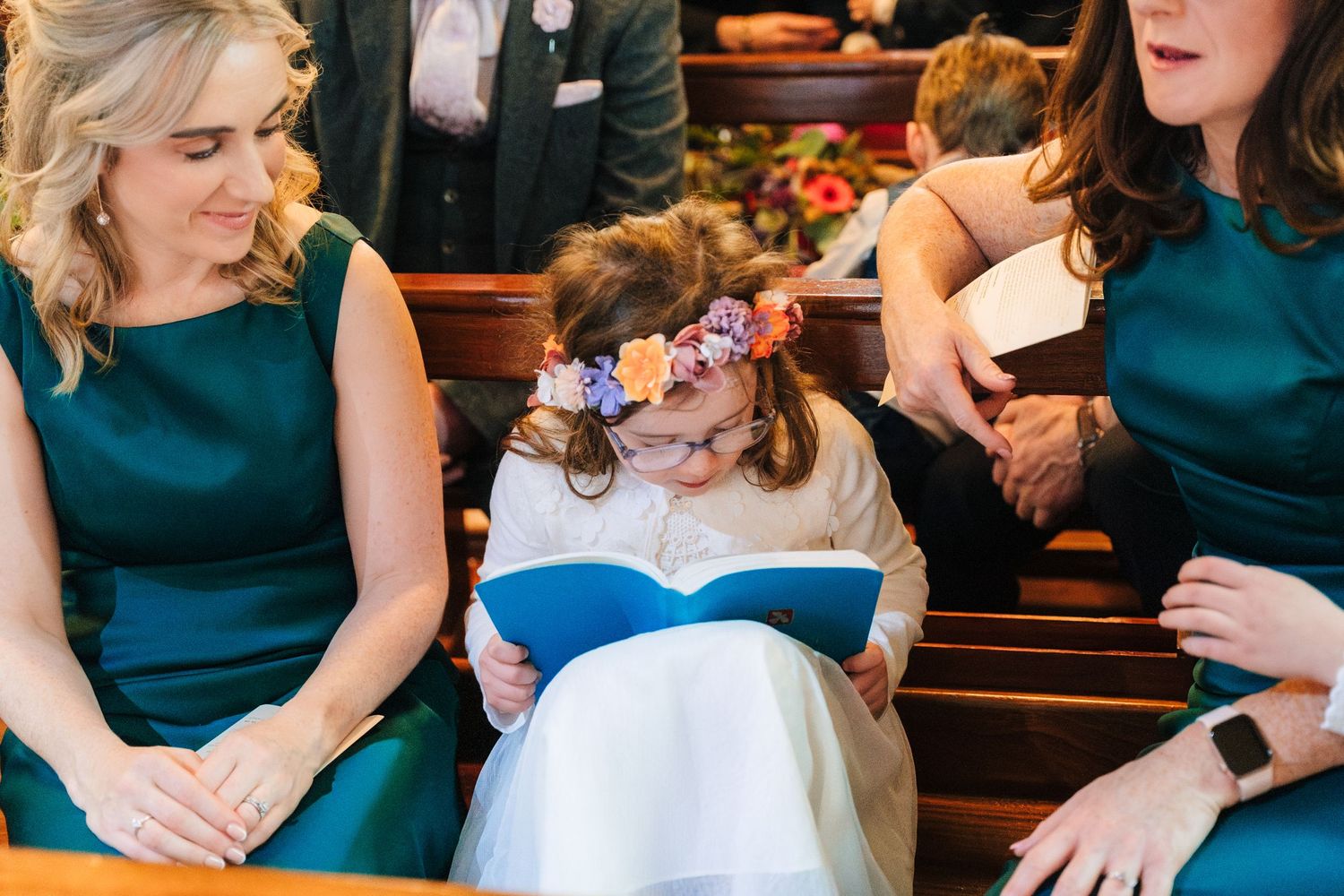 Wedding party members in teal dresses gathered during the celebration.