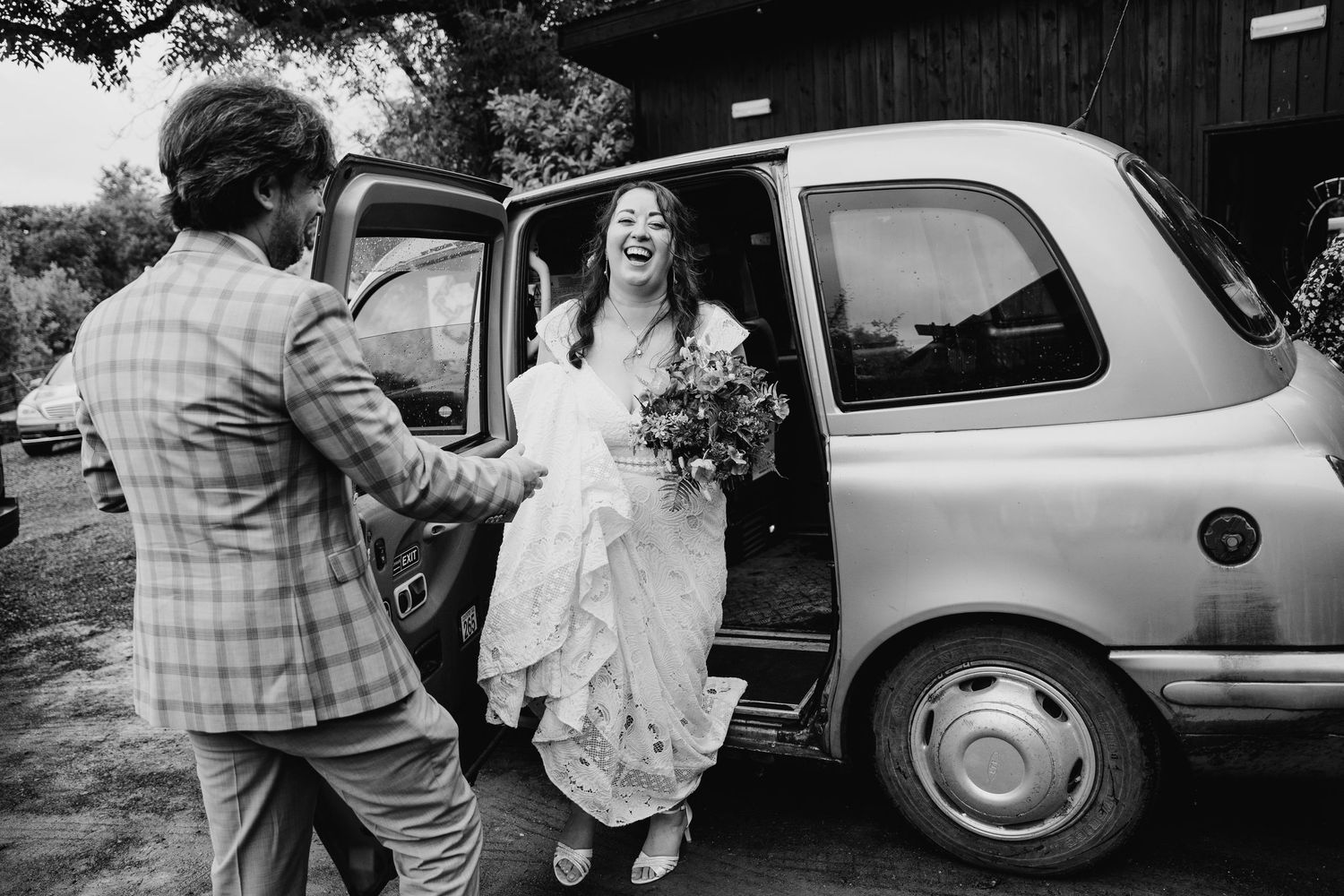 Candid moments captured outside vintage cars during a wedding celebration. Wedding photographer Dublin