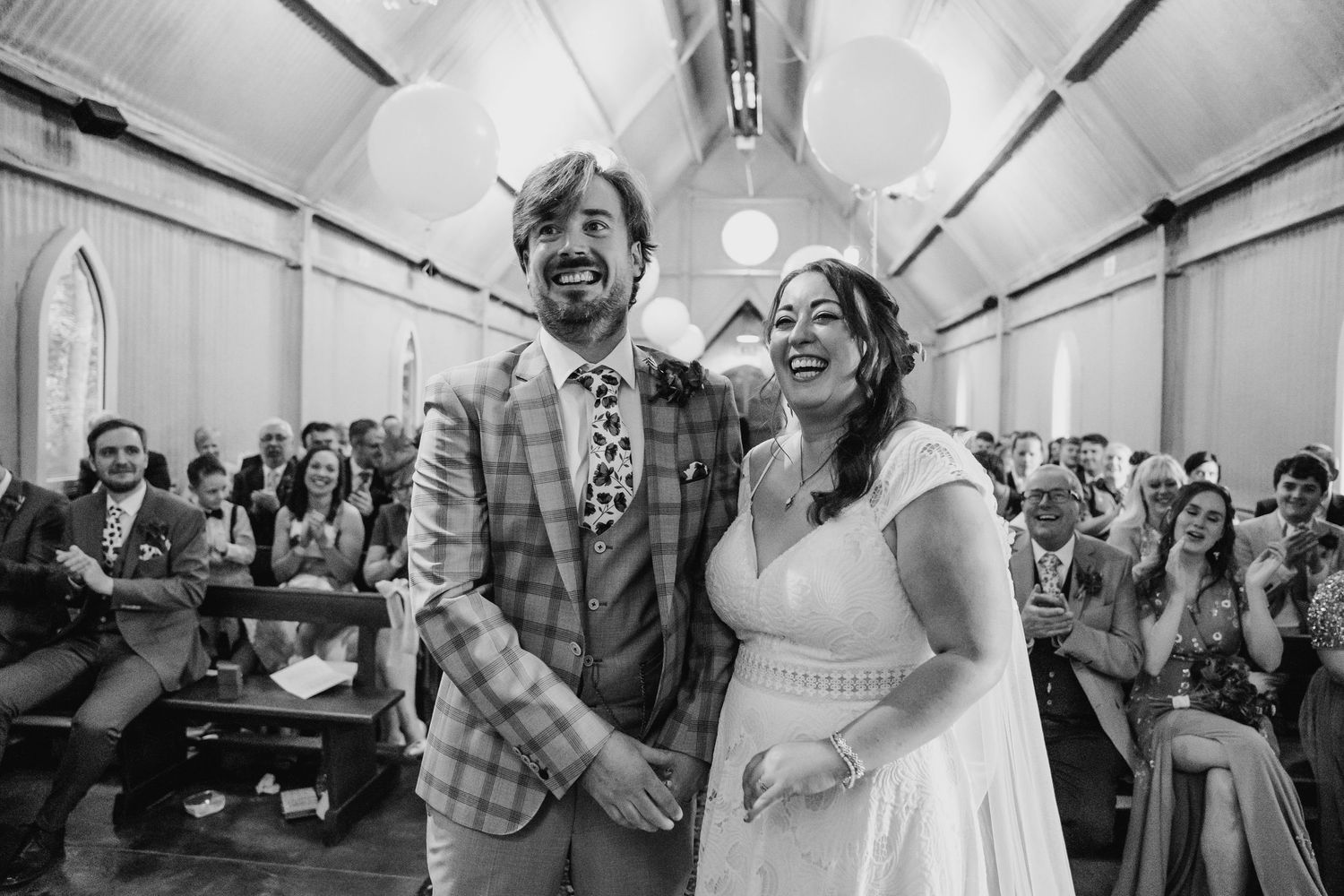 Wedding celebration in a bright indoor venue with guests gathered for festivities. Wedding photographer Dublin