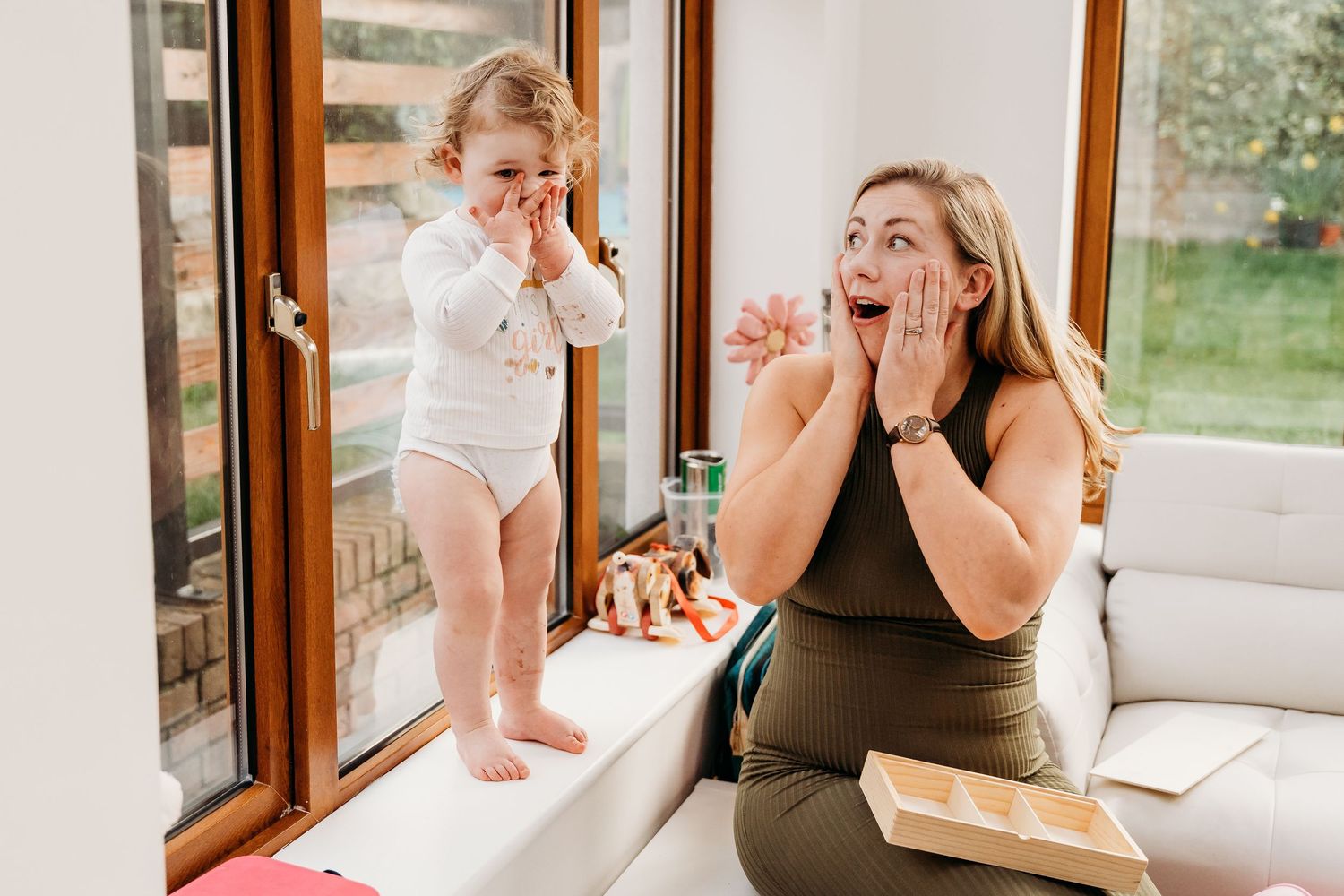 A sequence of photos showing a surprised emotional reaction while opening a special gift or letter. family photographer dublin