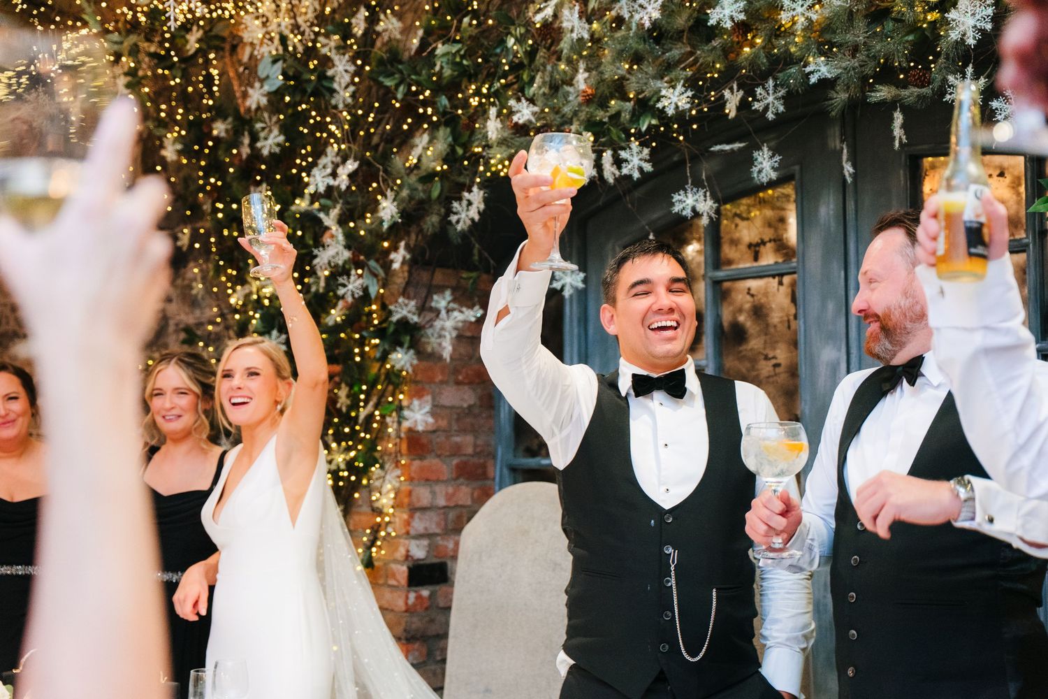 Wedding party celebrating under twinkling lights at evening reception. Ballymagarvey Wedding photographer