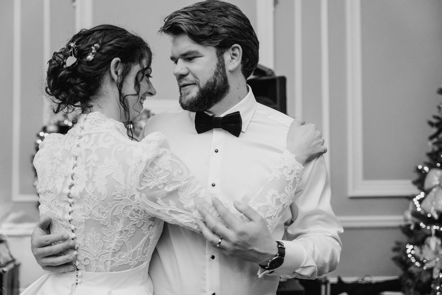 Black and white photo of couple dancing in an elegant ballroom with classic decor. Stephens green club dublin Wedding photographer
