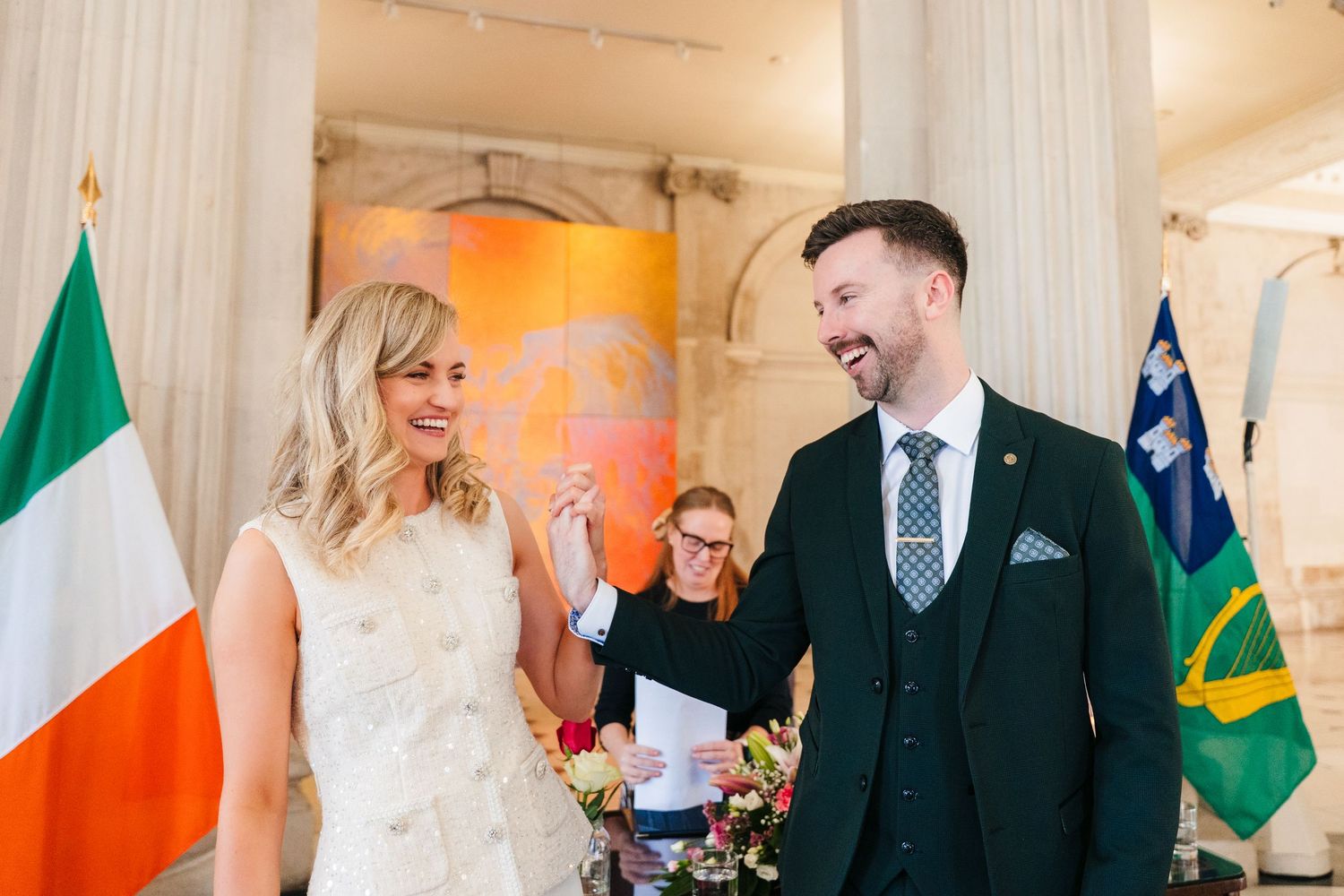Wedding celebration in grand hall with international flags and classical columns. City Hall Dublin wedding photogrAPher