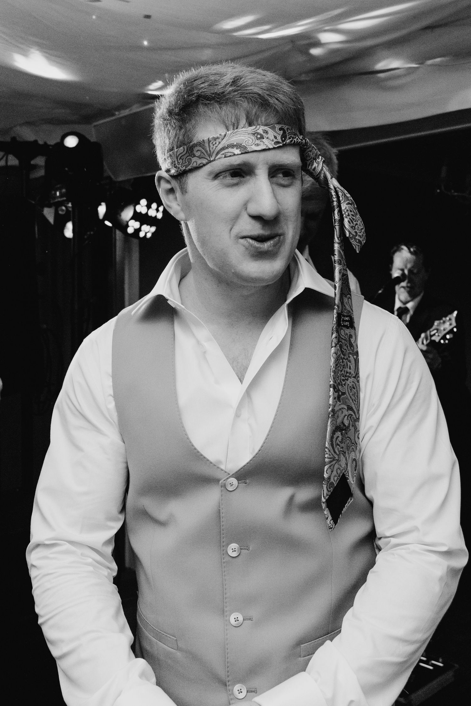 Millhouse slane wedding photographer dublin Black and white portrait of guest wearing bandana headband at wedding celebration.