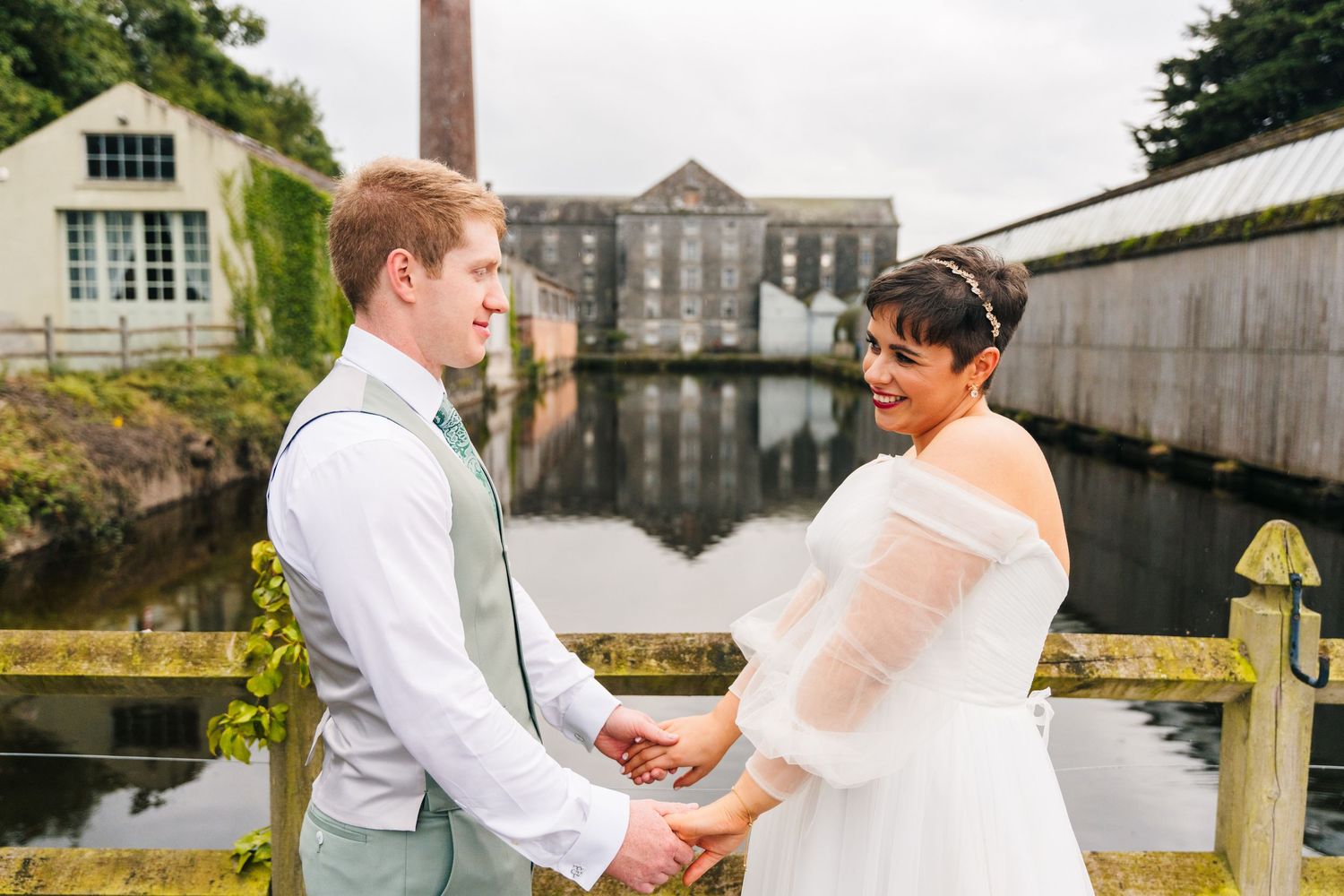 Millhouse slane wedding photographer dublin Wedding venue exterior with historic brick building and waterfront view.