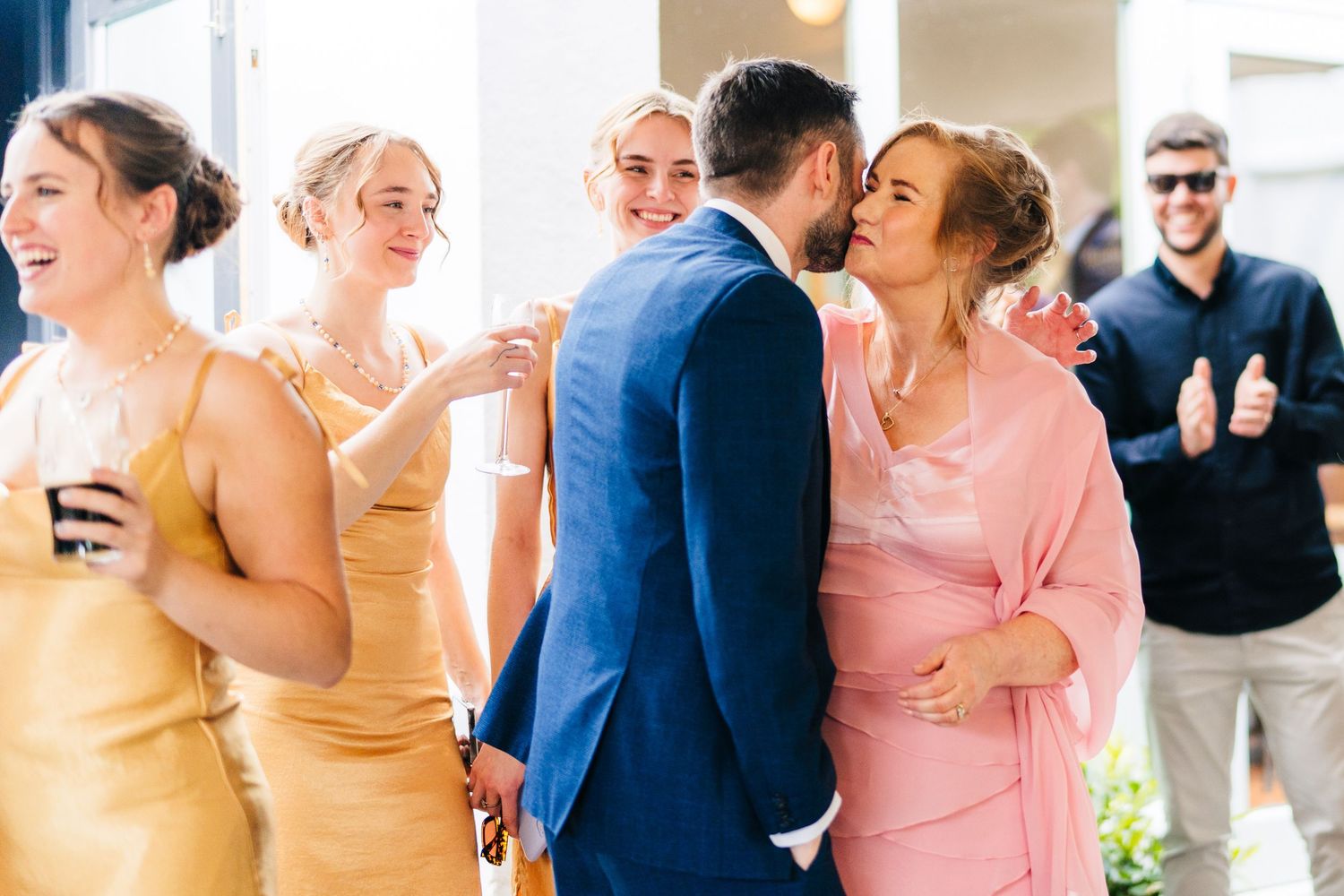 Poulaphouca Wedding photographer wicklow  Wedding celebration scene with people in formal attire gathered for a festive moment.