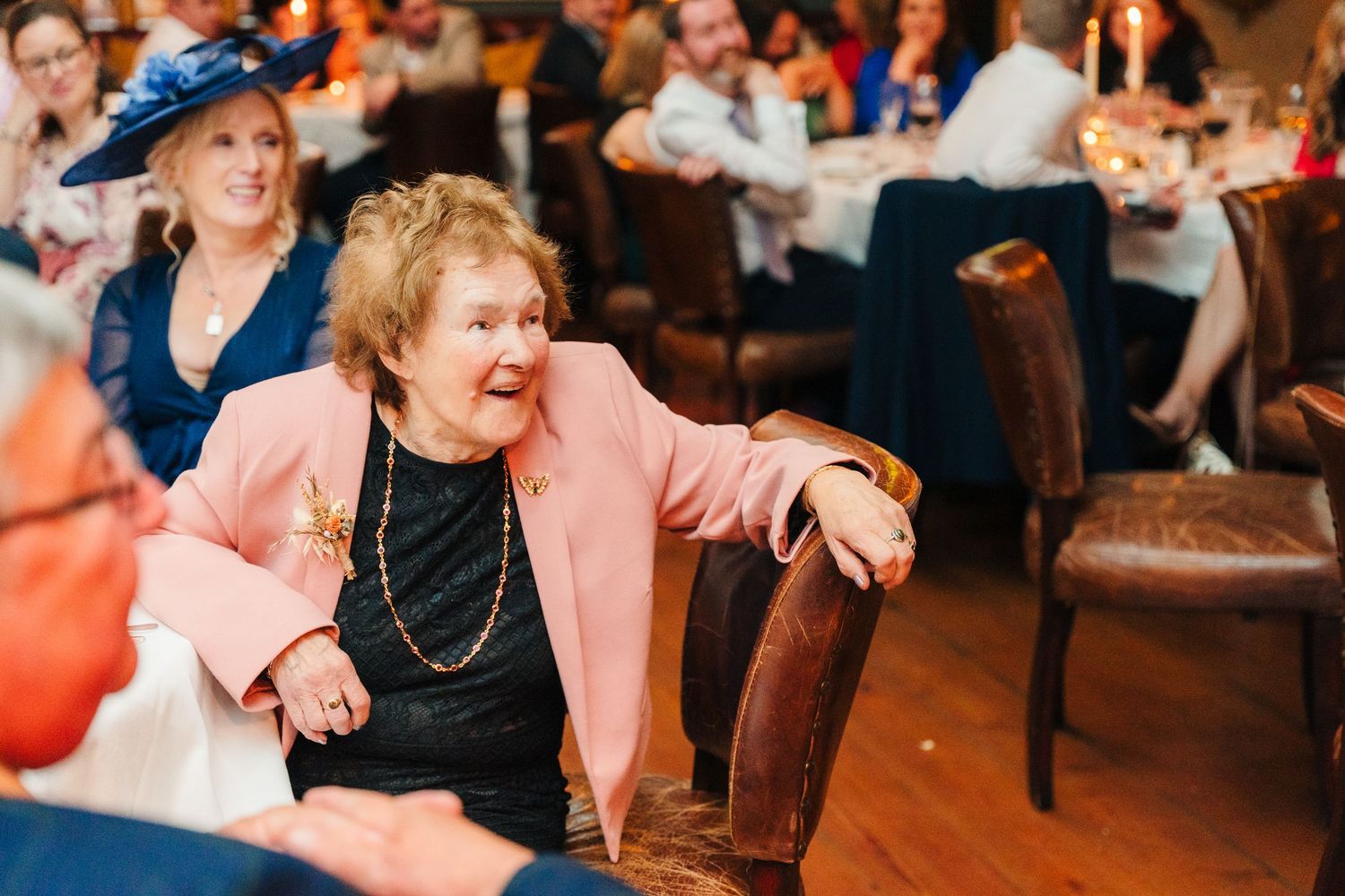 Lively celebration at a wedding reception with guests enjoying drinks at a bar.