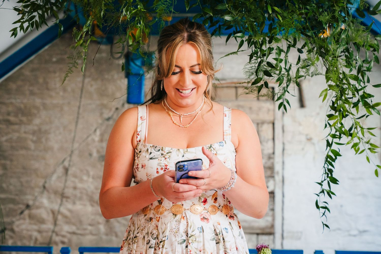 People taking phone photos near stone walls with hanging greenery decorations. Same sex wedding PHOTOGRAPHER Dublin