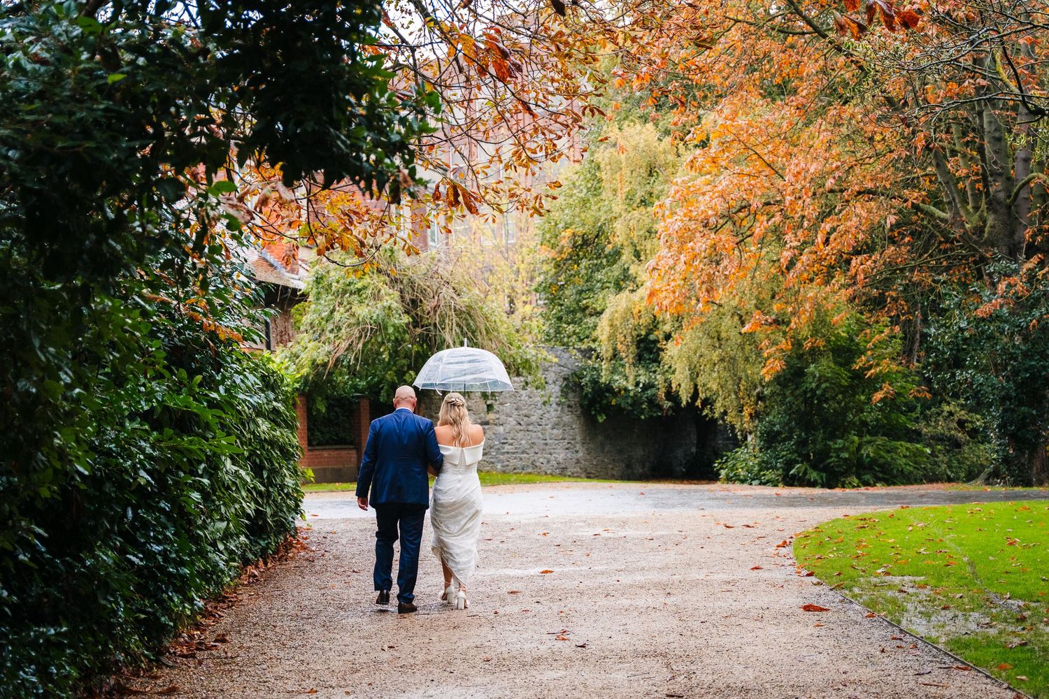 Autumn pathway lined with colorful trees and landscaping during fall season. The Dean Dublin Wedding Photographer