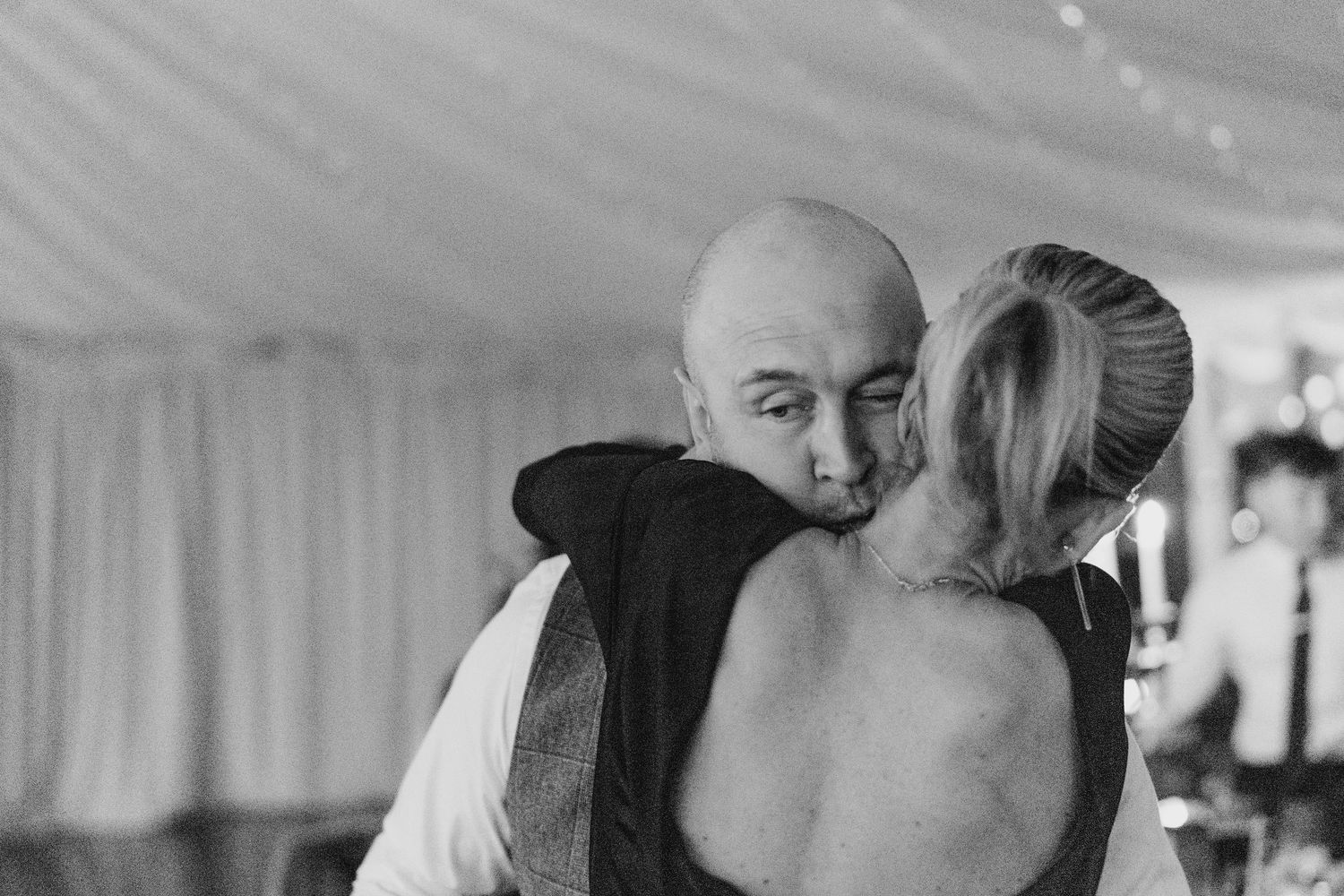 A group of wedding guests dancing and celebrating together at a lively indoor reception.  Virginia Park Lodge Wedding Photographer Cavan Dub