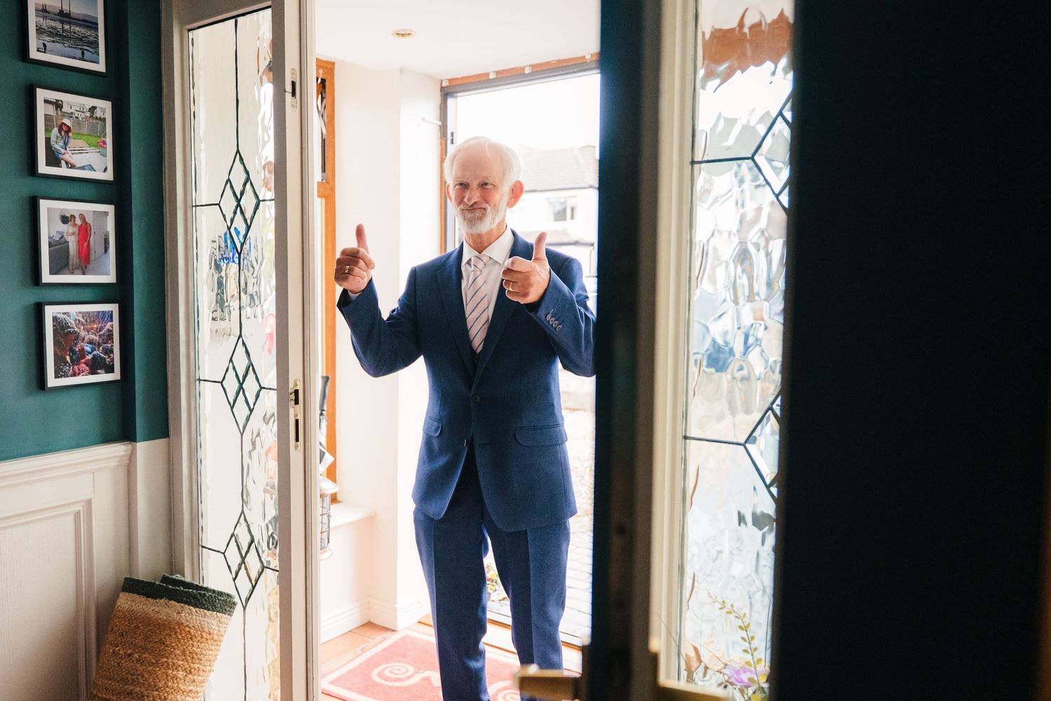 Three black and white photos showing someone in formal wear standing by windows with decorative glass panels. The Dean Dublin Wedding Photog