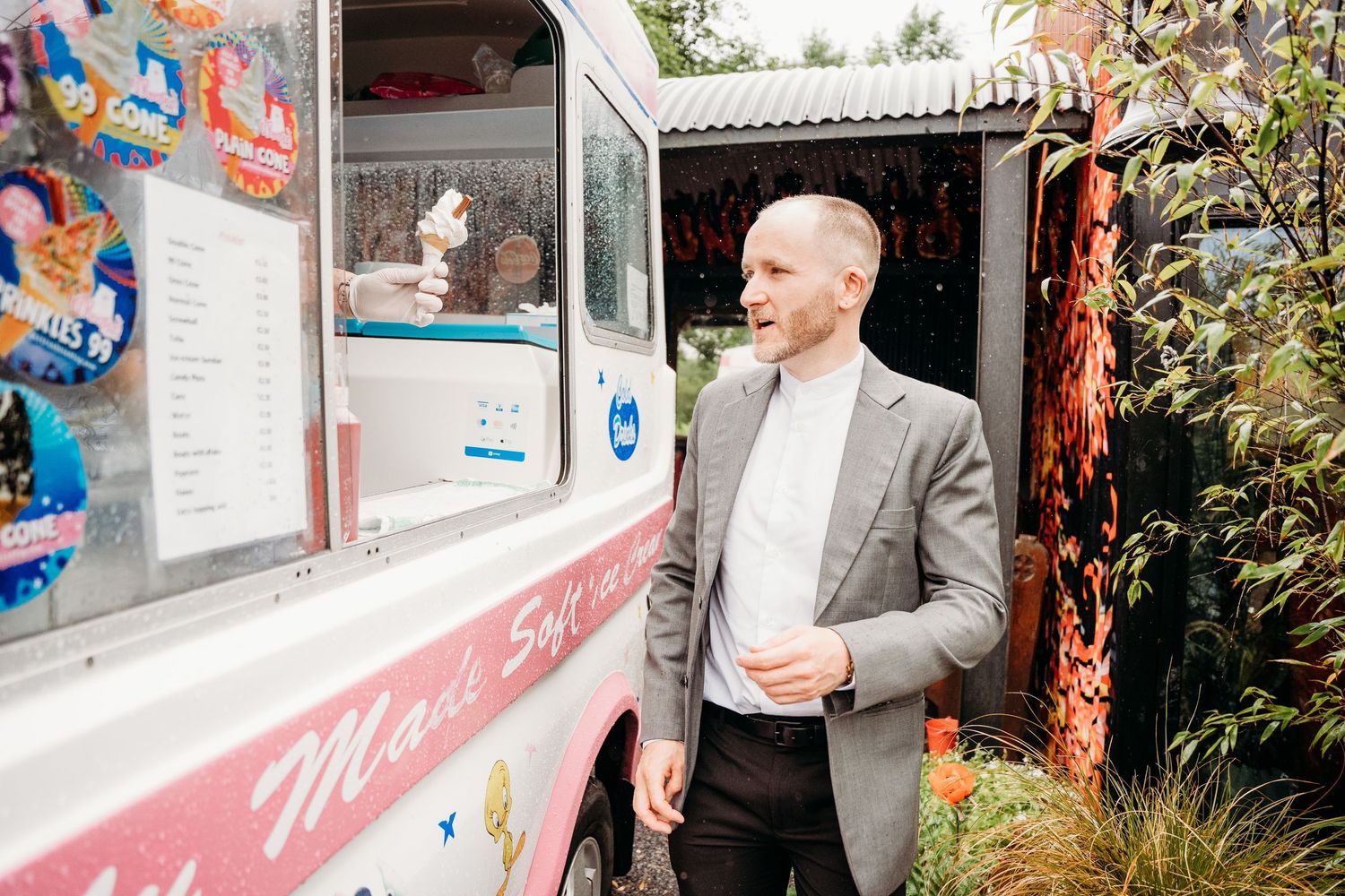Wedding guests getting refreshments from a vintage food truck at outdoor celebration. Wedding photographer Dublin