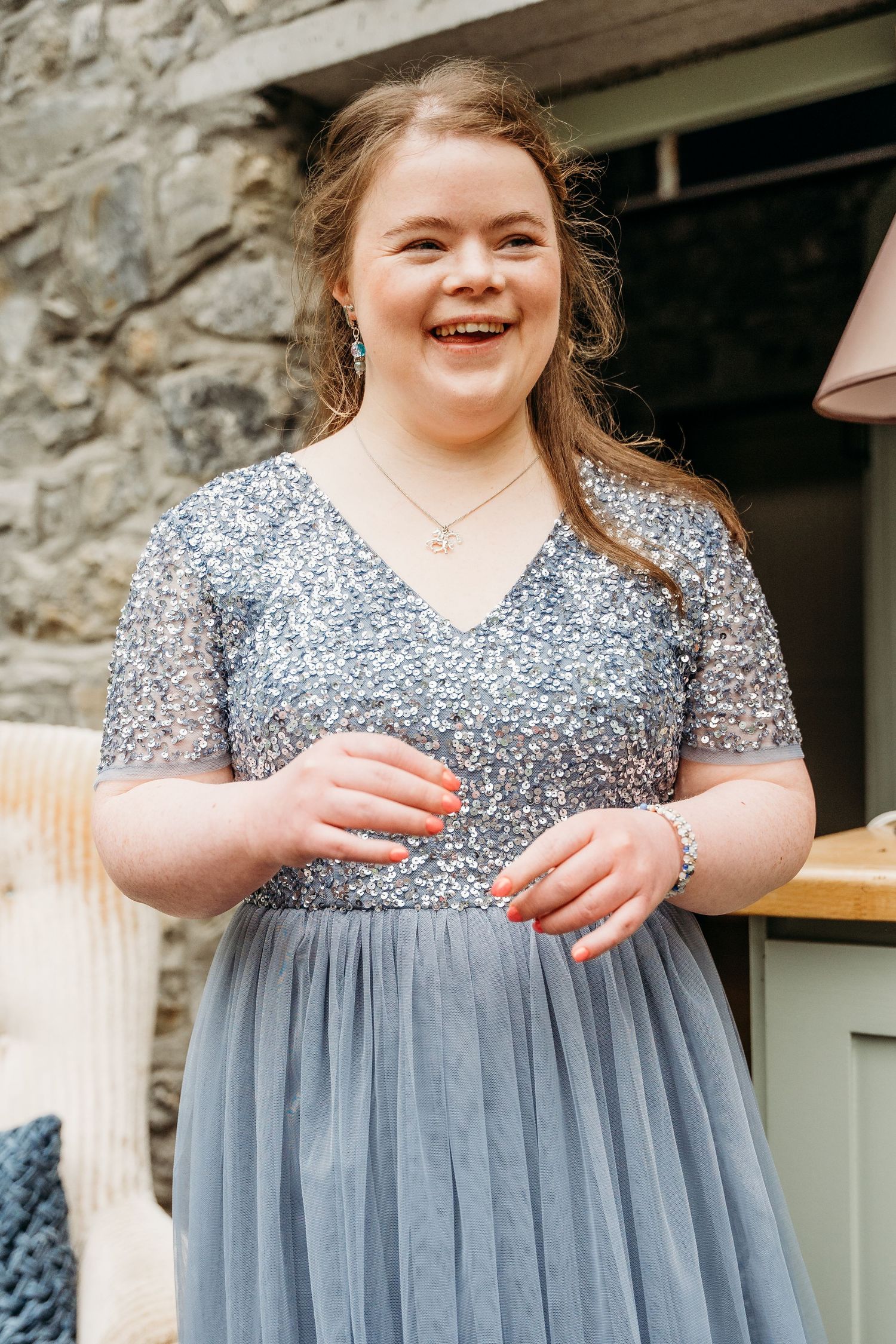 Person wearing a sparkly grey dress with tulle skirt smiles outdoors. Wedding photographer Dublin