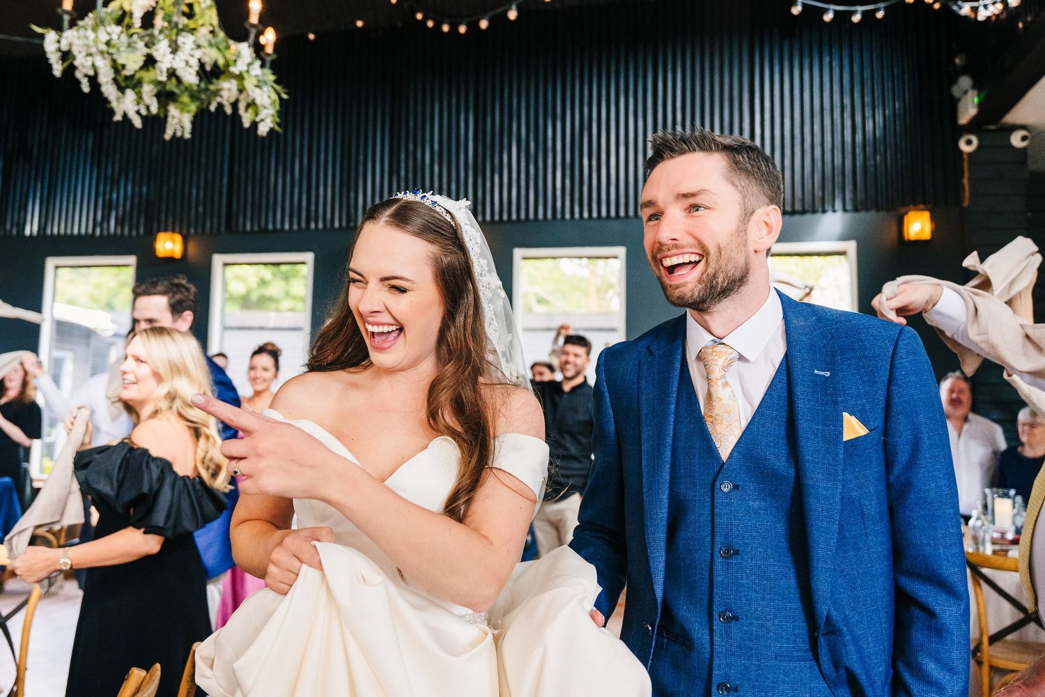 A wedding couple and guests celebrate joyfully with champagne spraying during an outdoor reception celebration. wedding photographer dublin