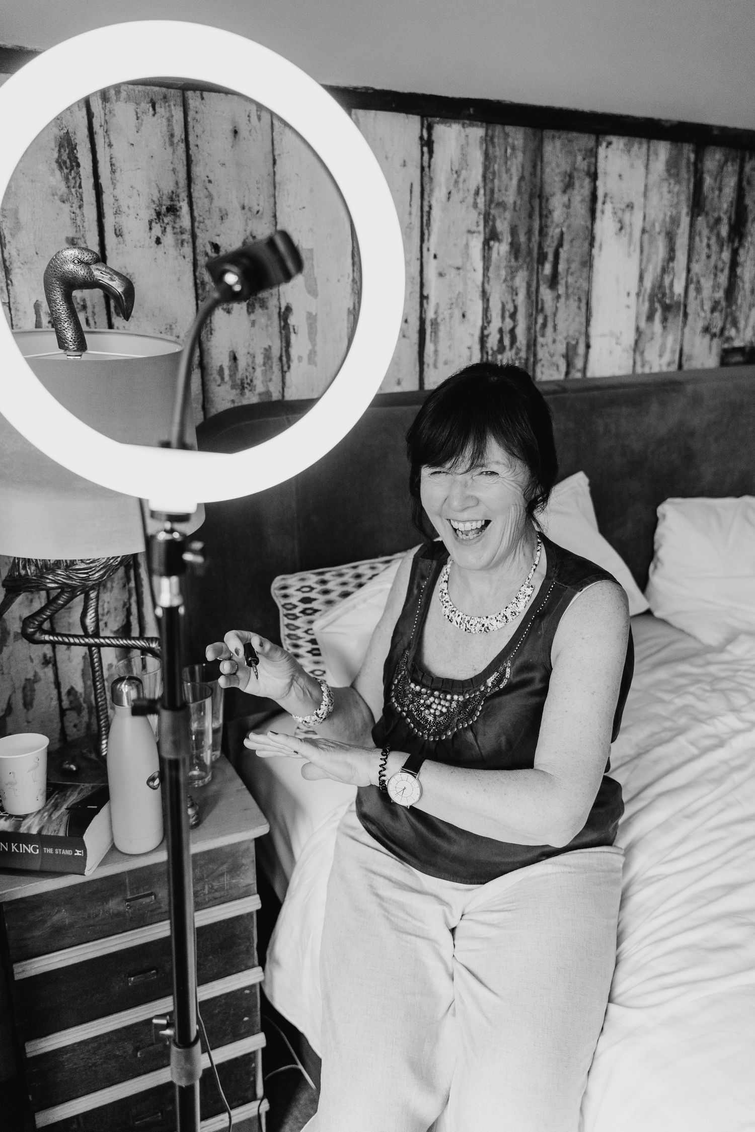Black and white series of joyful moments in a bedroom with rustic wood walls. House Dublin Wedding Photographer