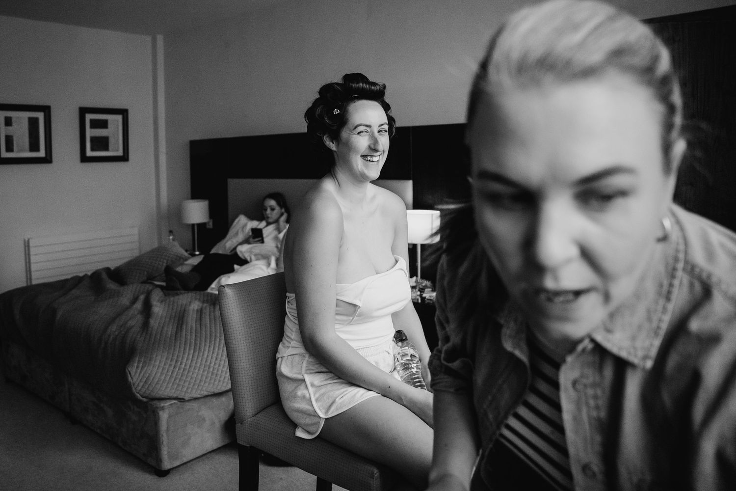 Black and white candid wedding photo showing preparation moment in hotel room. Wedding Photography Trim Castle Ireland