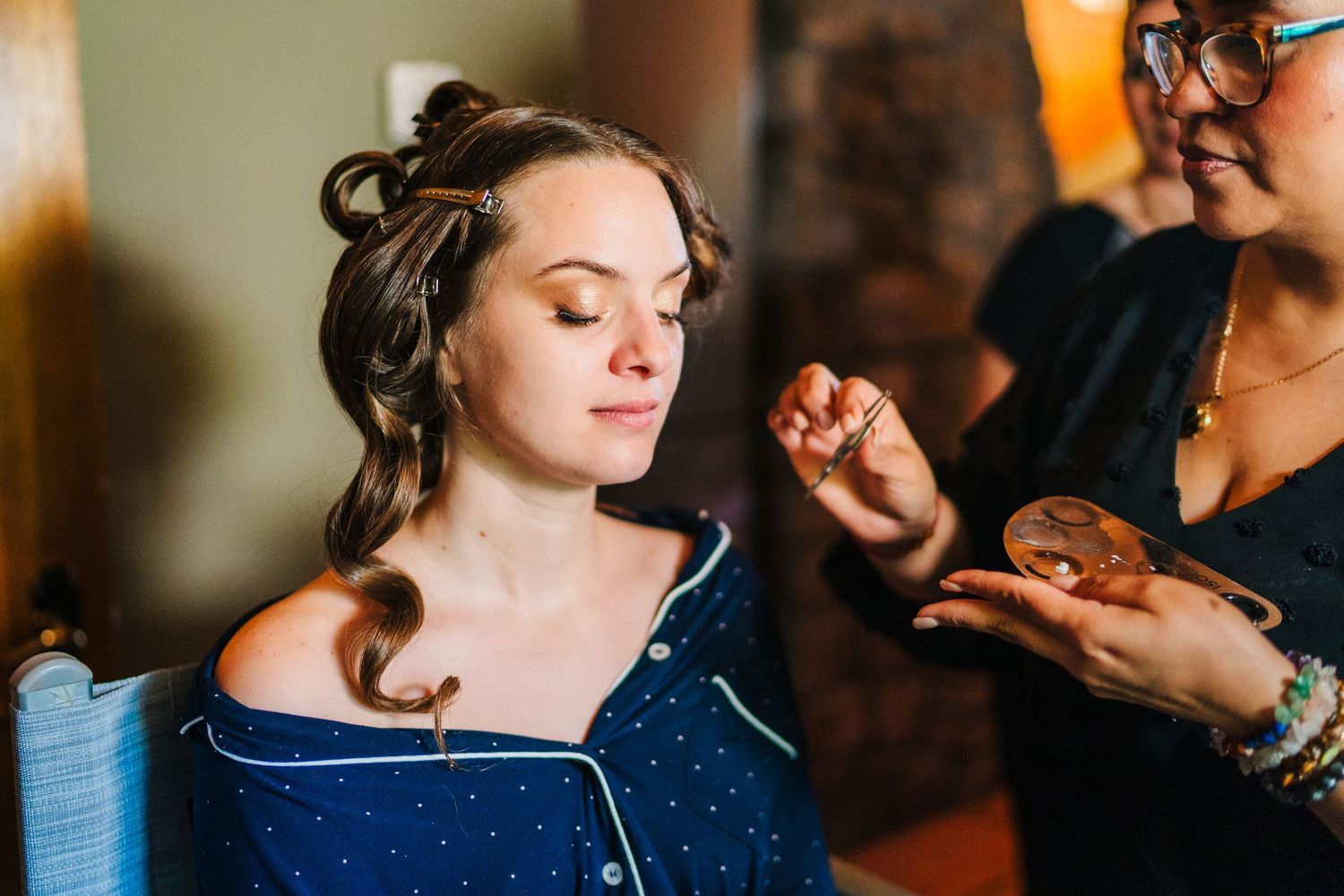 Poulaphouca Wedding photographer wicklow  Wedding party getting ready in a warmly lit indoor setting with natural window light.