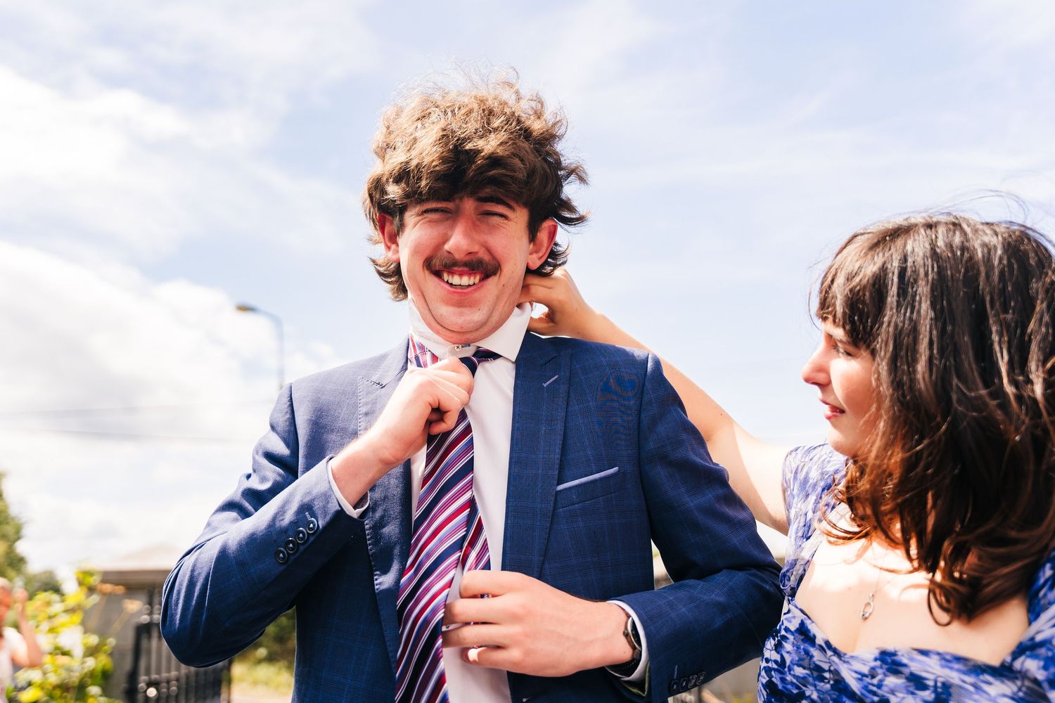 Millhouse slane wedding photographer dublin Happy wedding guests laugh and socialize together during an outdoor celebration gathering.
