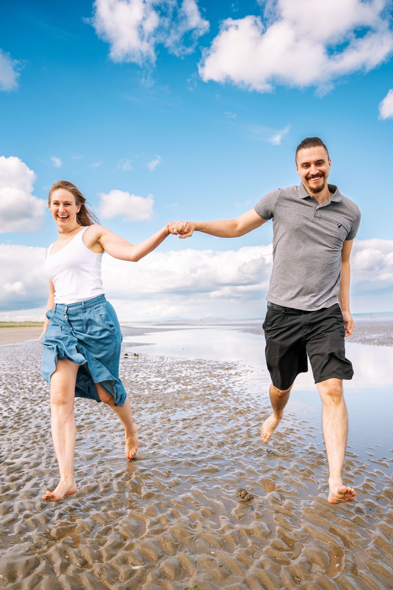 A series of photos showing people splashing and playing in shallow ocean water on a sunny beach day with blue skies. PHOTOGRAPHER Dublin ire