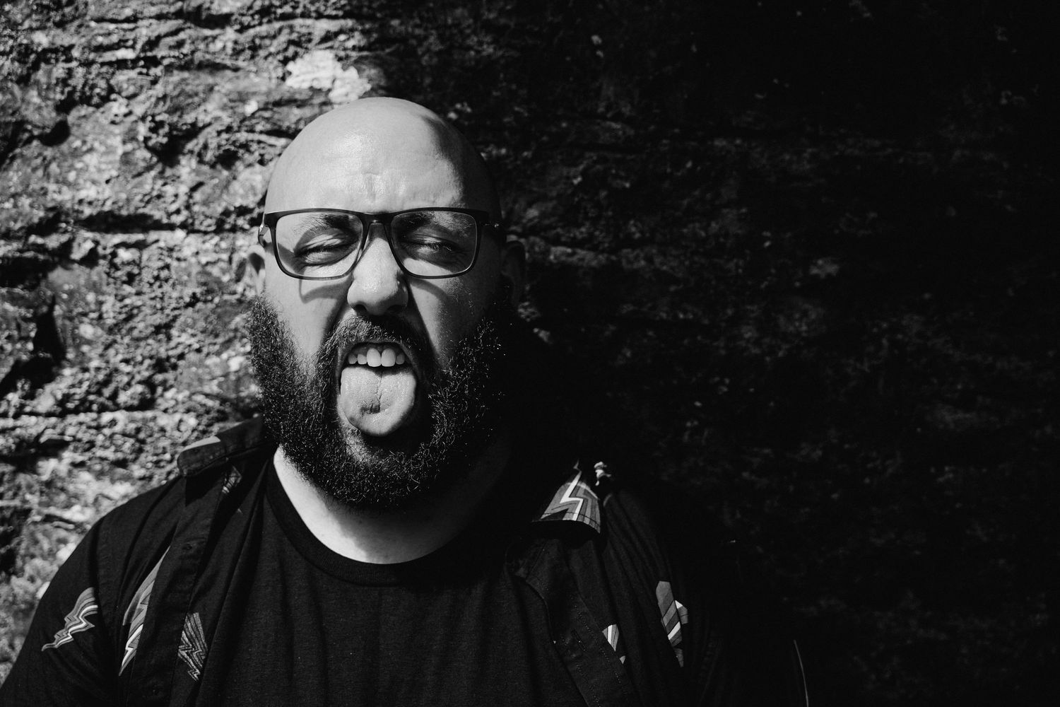 Black and white photo capturing expressions against a stone wall backdrop. PHOTOGRAPHER Dublin ireland