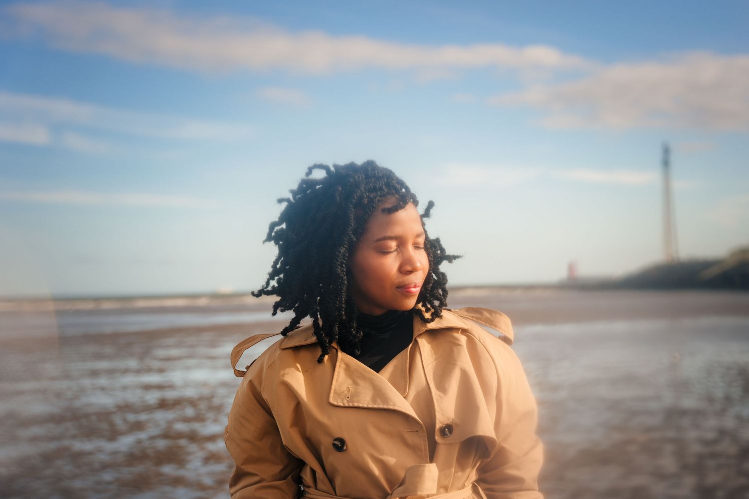 Artistic beach photoshoot featuring dynamic movement against cloudy coastal backdrop. Dublin professional headshots photographer