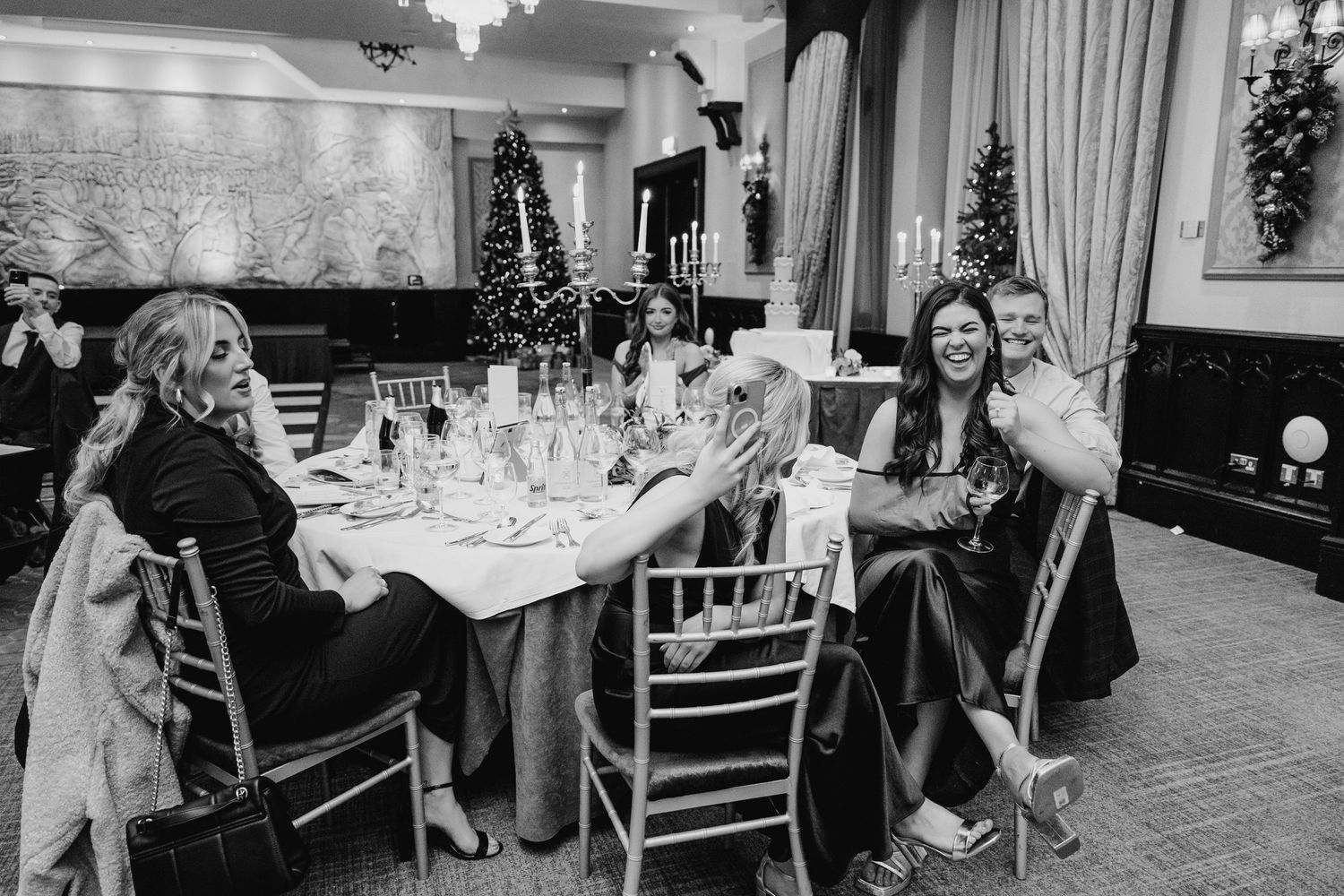Black and white photo of wedding reception tables set with elegant decor and floral centerpieces. Wedding photographer dublin