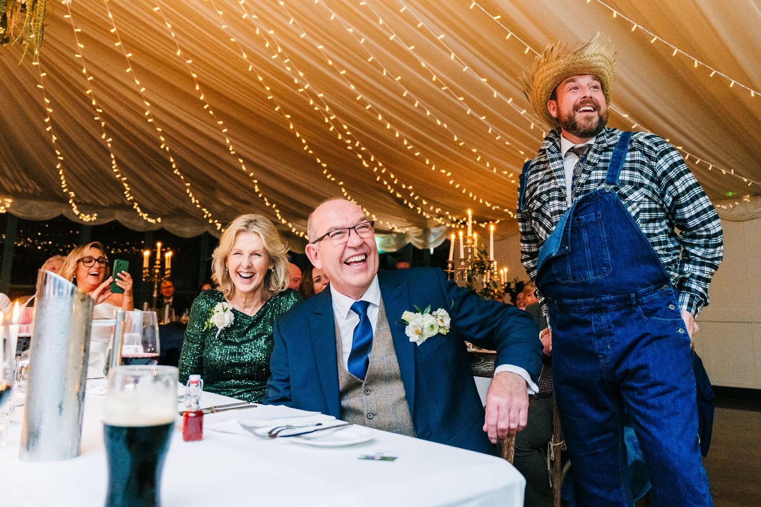 Wedding reception venue decorated with string lights and white table settings.  Virginia Park Lodge Wedding Photographer Cavan Dublin Irelan