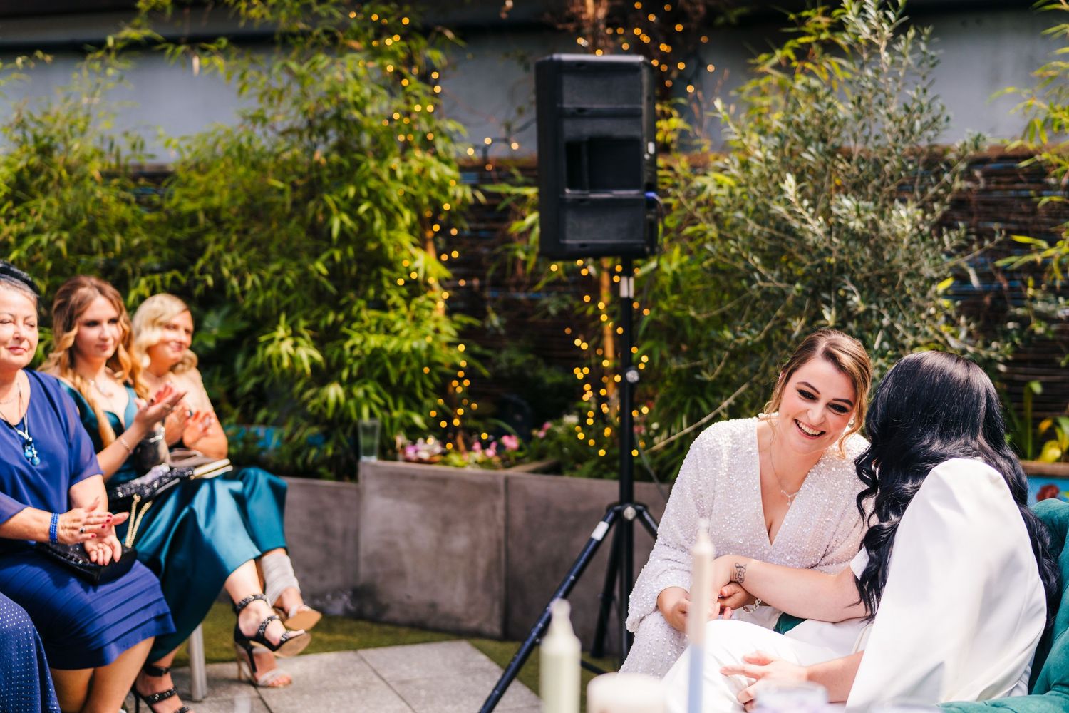 A casual outdoor celebration with guests gathered in a garden setting. House Dublin Wedding Photographer