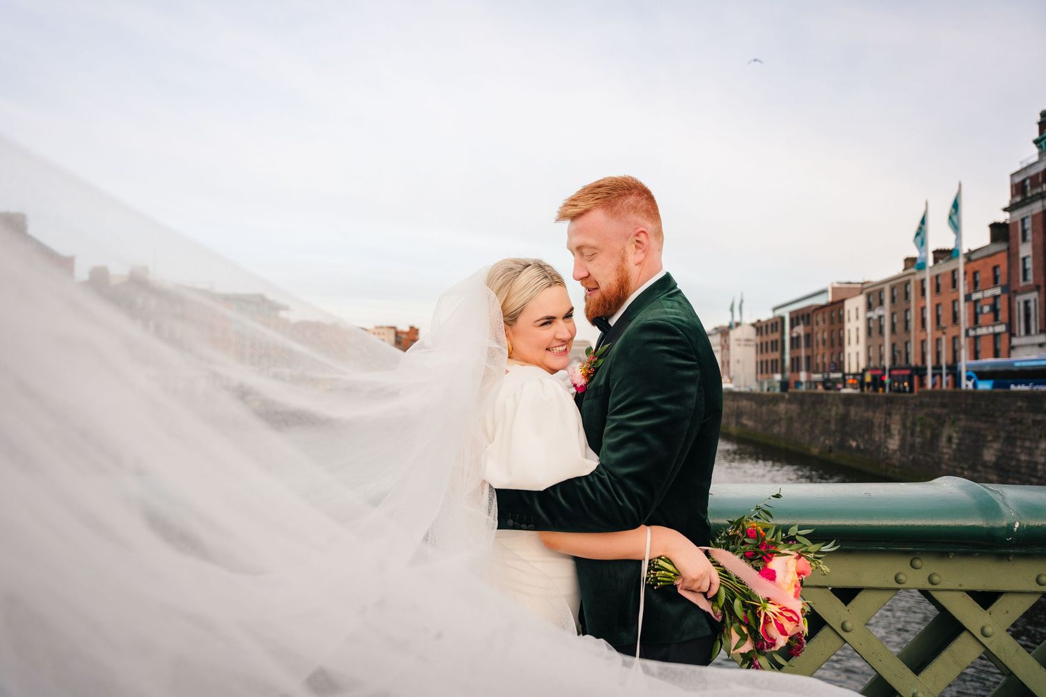 Romantic wedding portrait with flowing veil against an urban waterfront backdrop. City Hall Dublin Photographer
