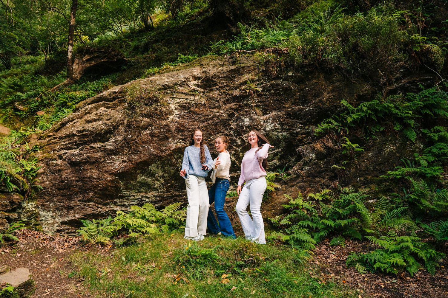 Family photographer Ireland Dublin Family photoshoot in a lush green forest setting with natural foliage.