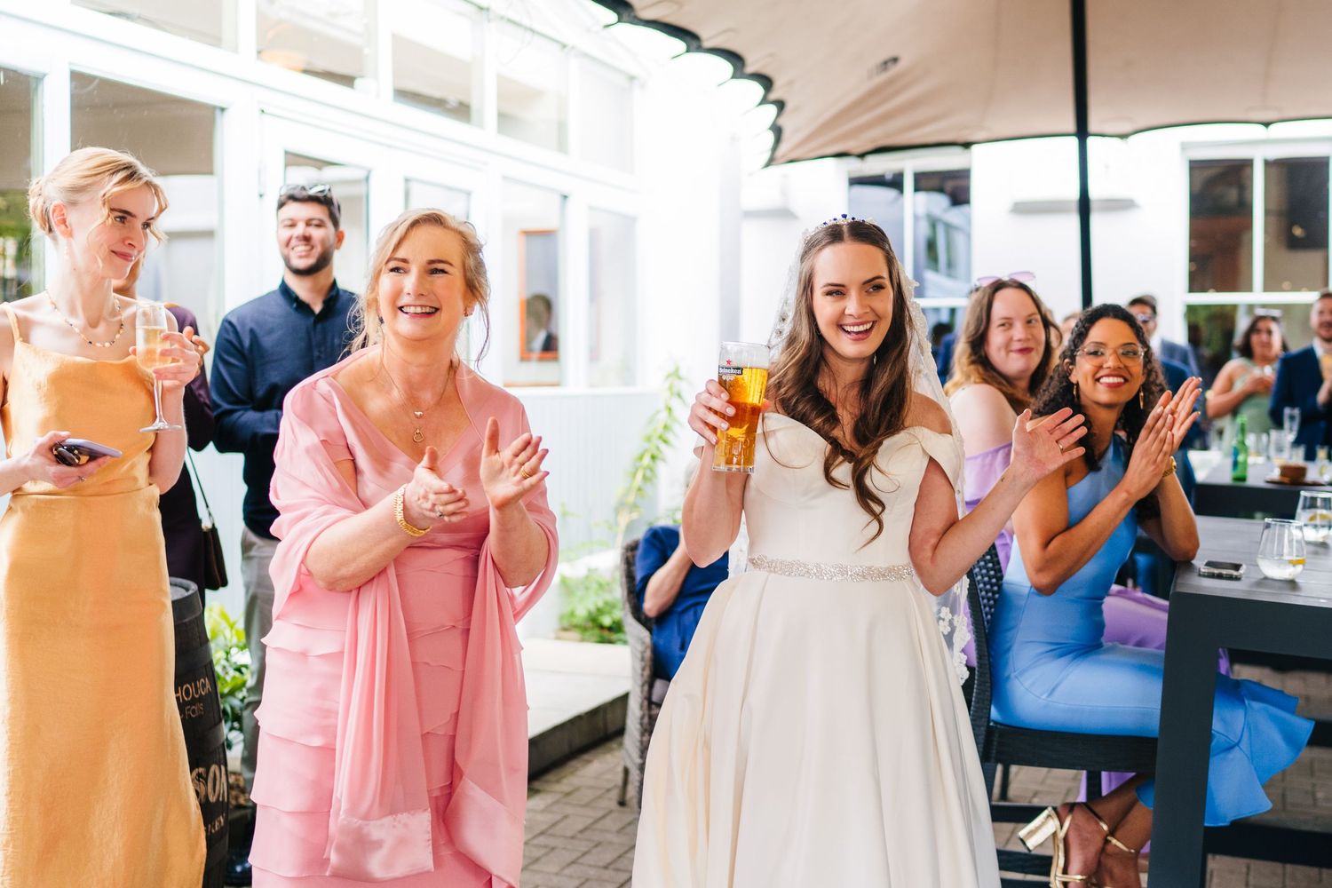 Poulaphouca Wedding photographer wicklow  Wedding celebration with guests enjoying drinks on an outdoor patio.