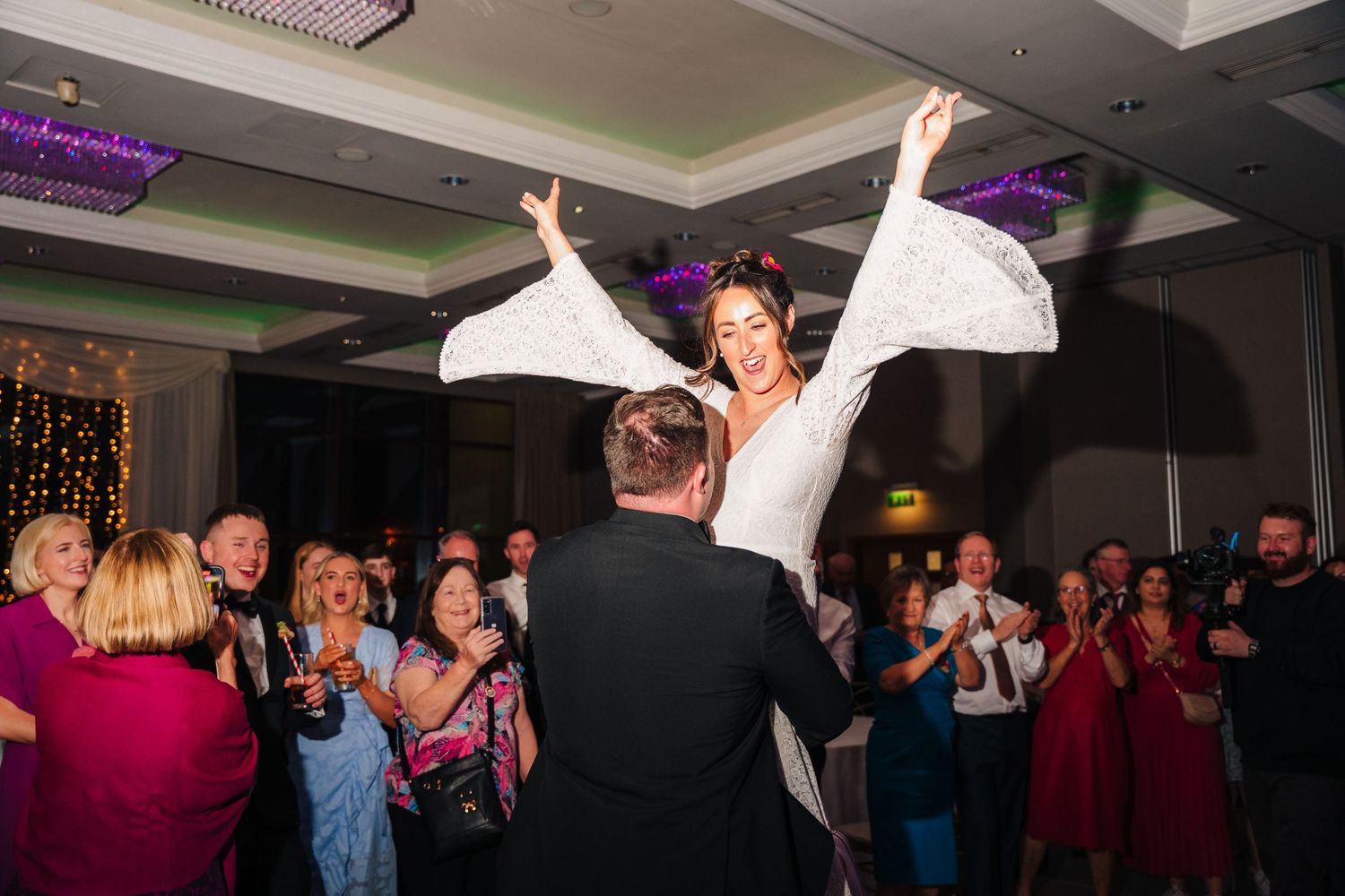 Wedding reception dance floor crowd silhouetted against colorful stage lighting.Wedding Photography Trim Castle Ireland\