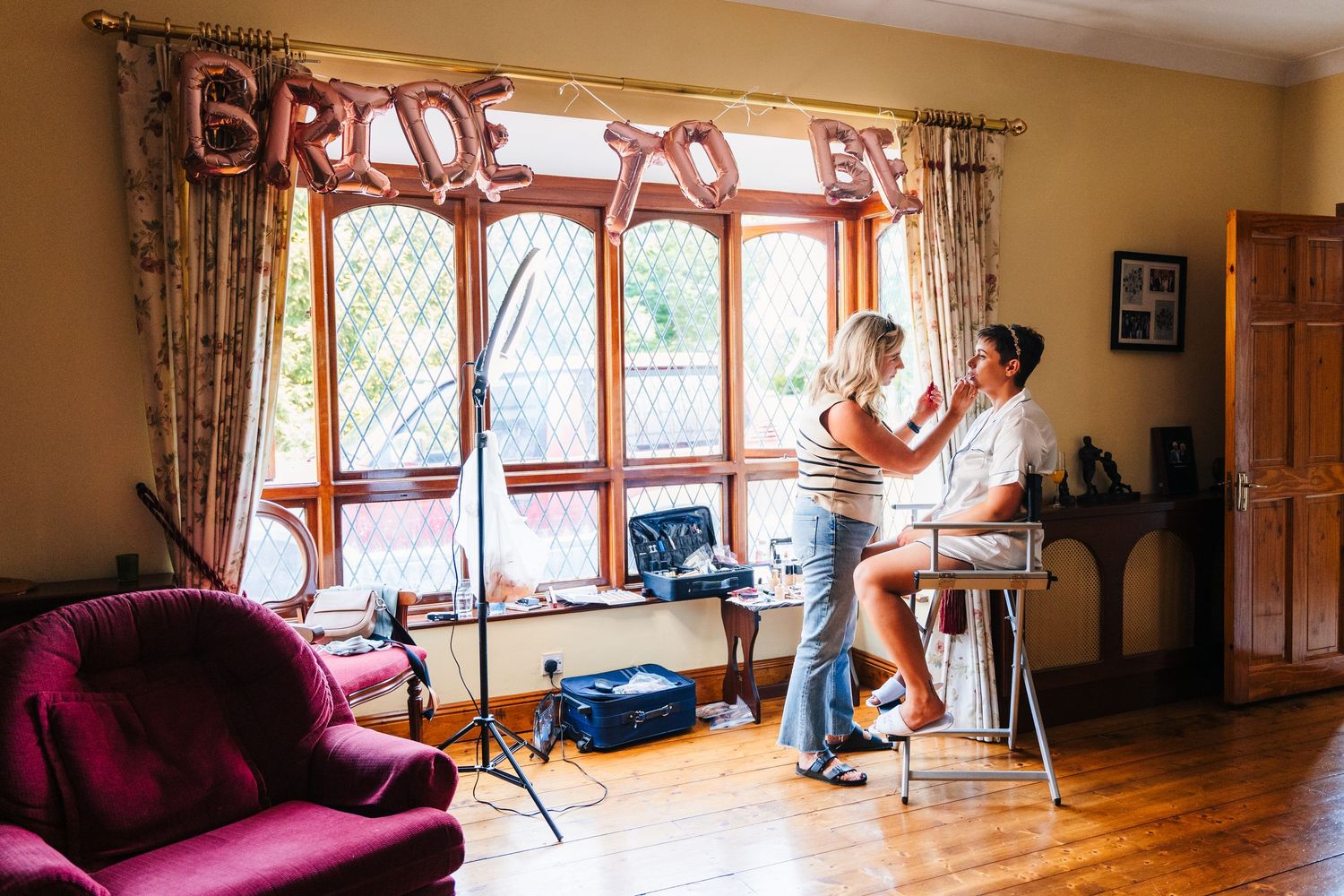 Millhouse slane wedding photographer dublin Getting ready in a sunny living room with hardwood floors and bay windows on the wedding day.