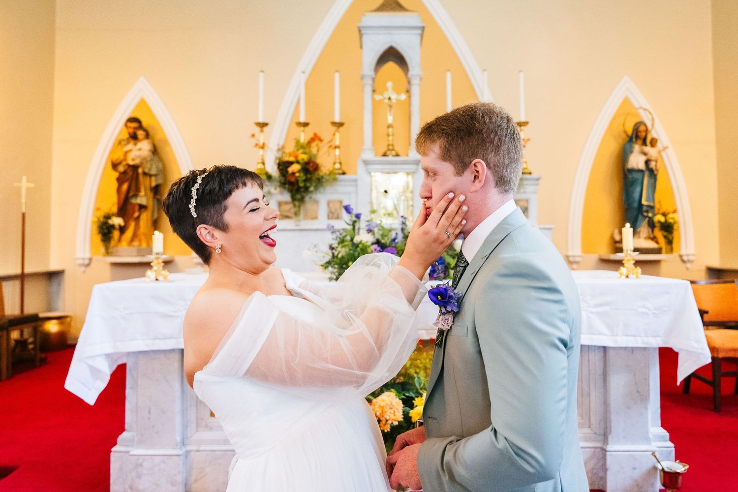 Millhouse slane wedding photographer dublin Couple sharing emotional moment during wedding ceremony in front of church altar.