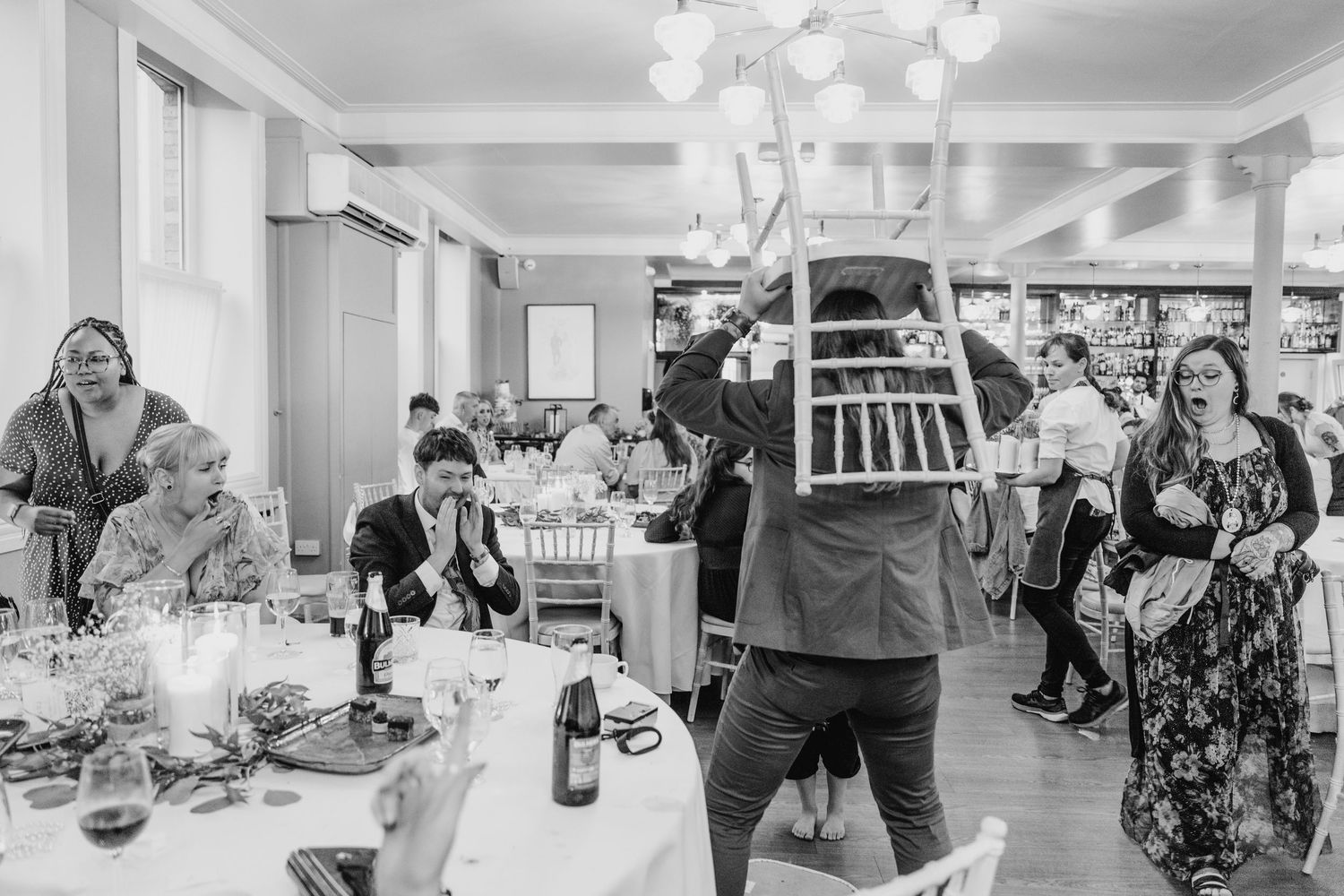 Modern wedding venue interior with white decor and chandelier lighting. PHOTOGRAPHER Dublin Ireland Wedding