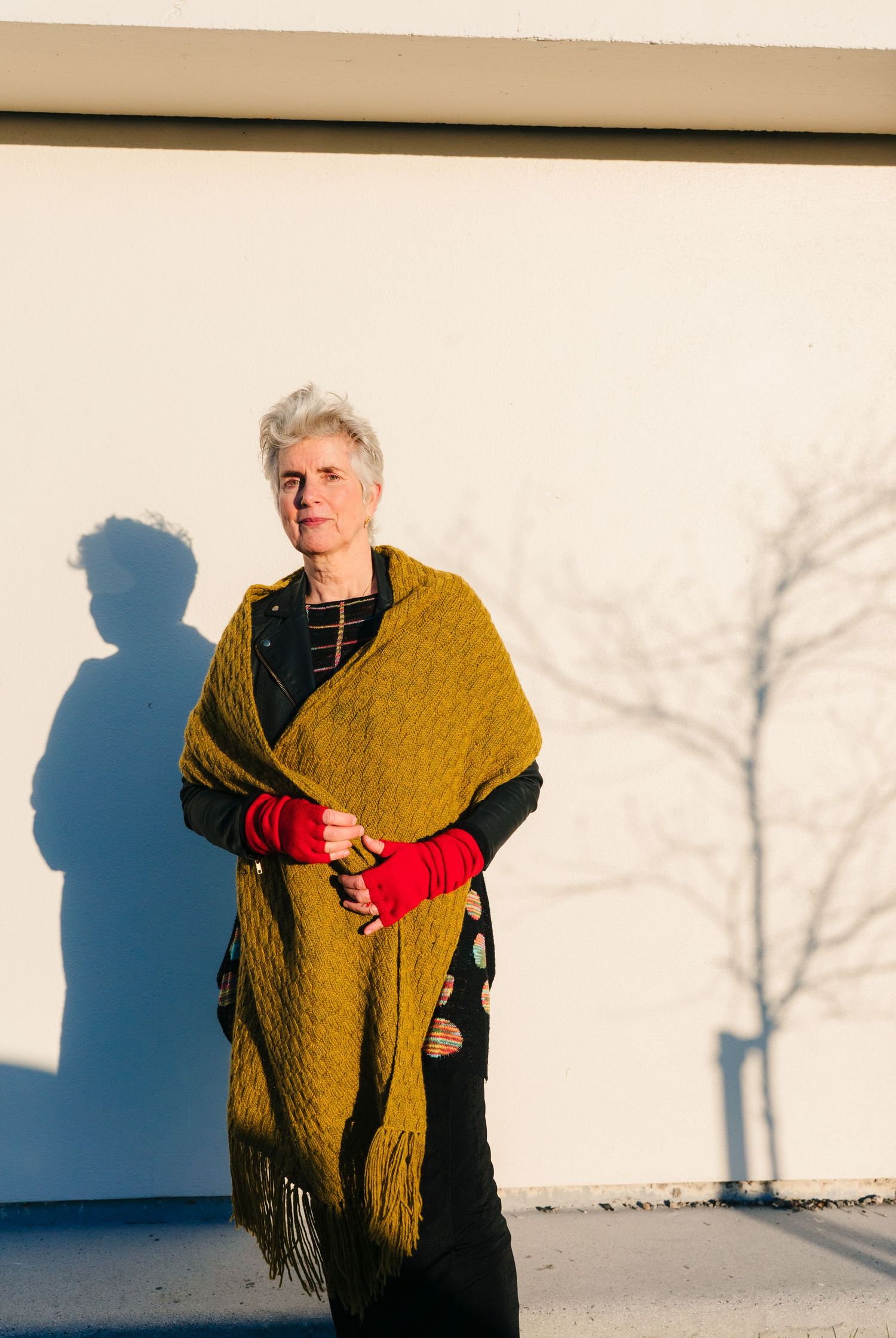 Minimalist portraits against white wall showing dramatic shadows and mustard yellow shawl. professional headshots branding photographer dubl