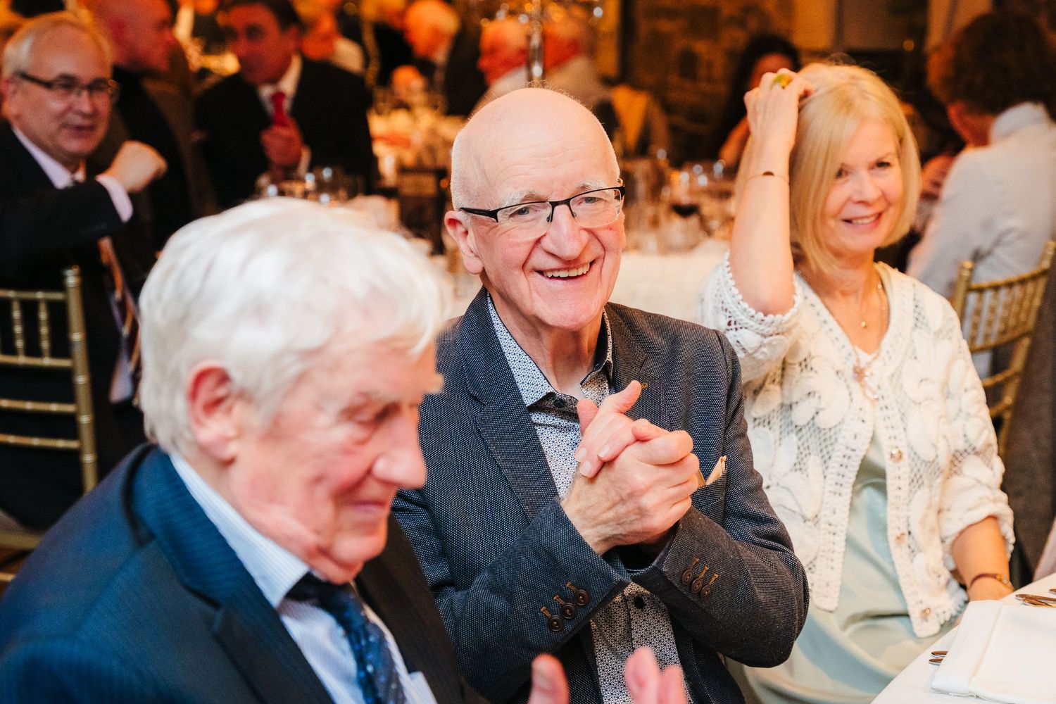 Candid moments of wedding guests laughing and celebrating at reception. Ballymagarvey Wedding photographer