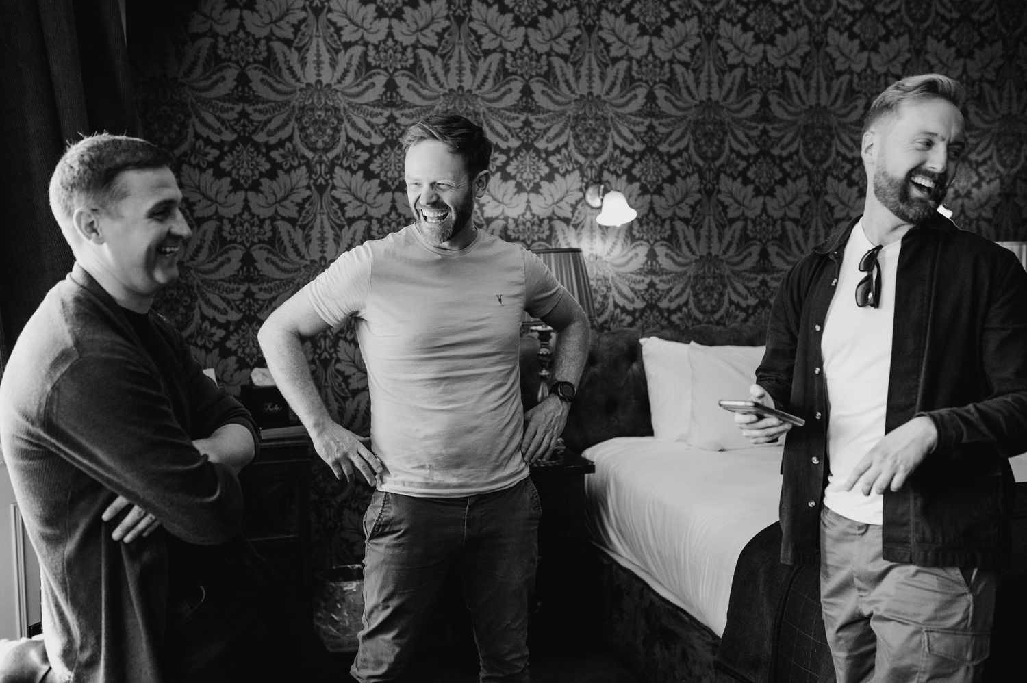Black and white panoramic photo shows people participating in a group exercise class in a studio. Castle Leslie Wedding Photographer Dublin