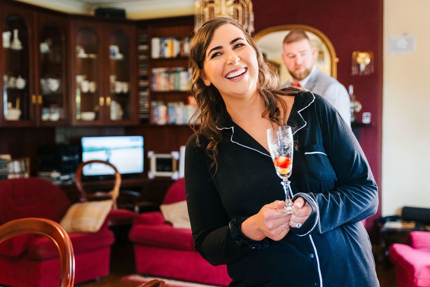 Professional businessperson enjoys a warm beverage in an upscale hotel lounge with rich red decor. Millhouse slane wedding photographer dubl