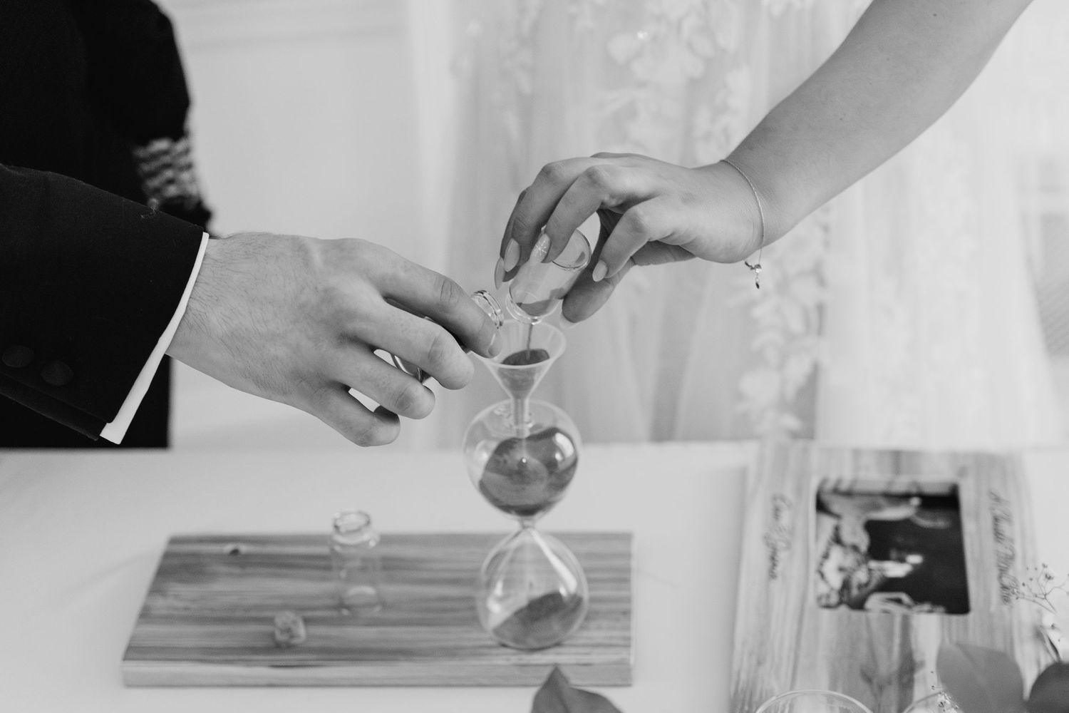 A person pours a liquid mixture through a paper filter into a glass vessel on a white surface.  Wedding PHOTOGRAPHER Dublin