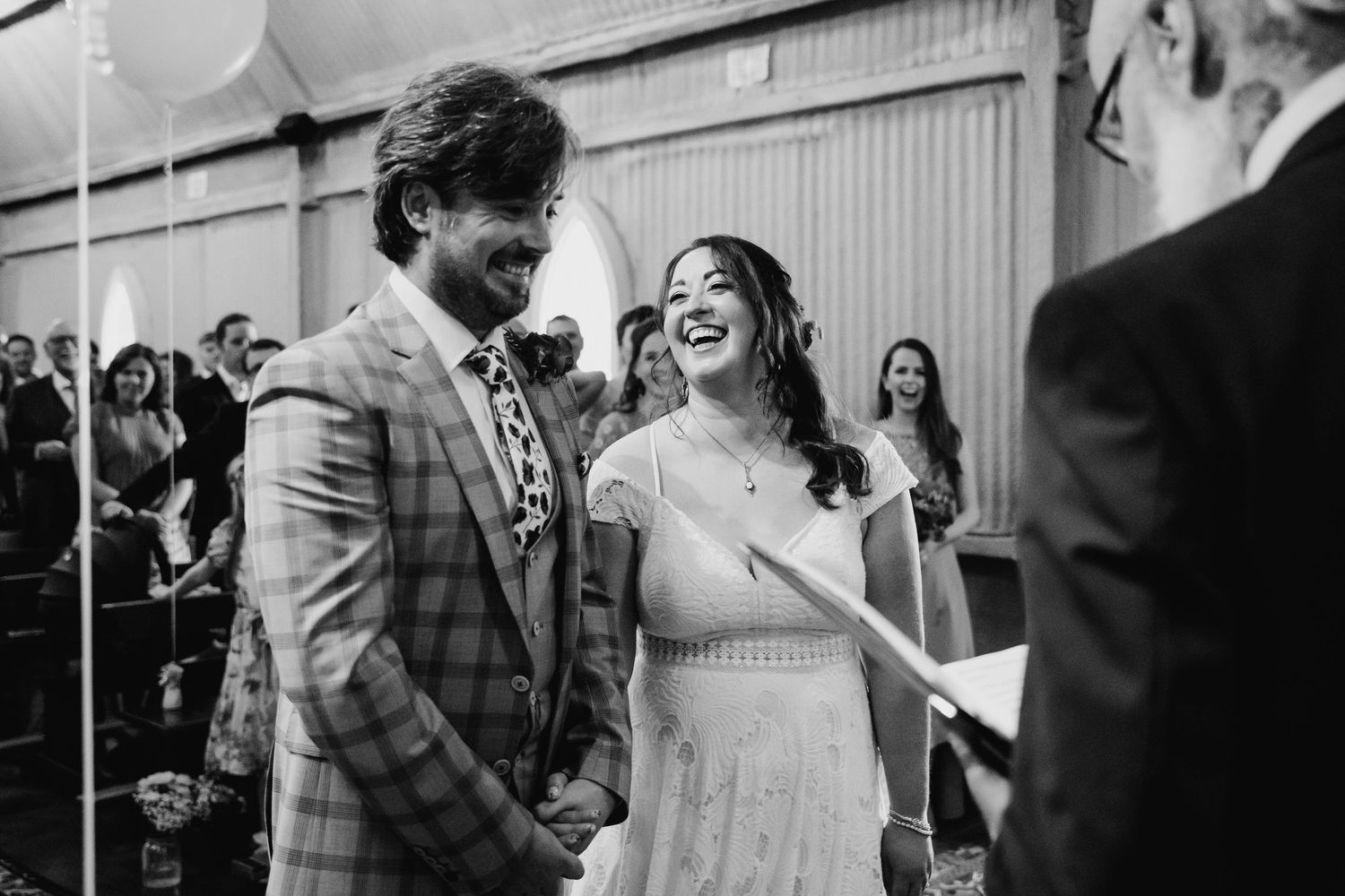 Wedding party celebrating with laughter and dancing at outdoor venue. Wedding photographer Dublin