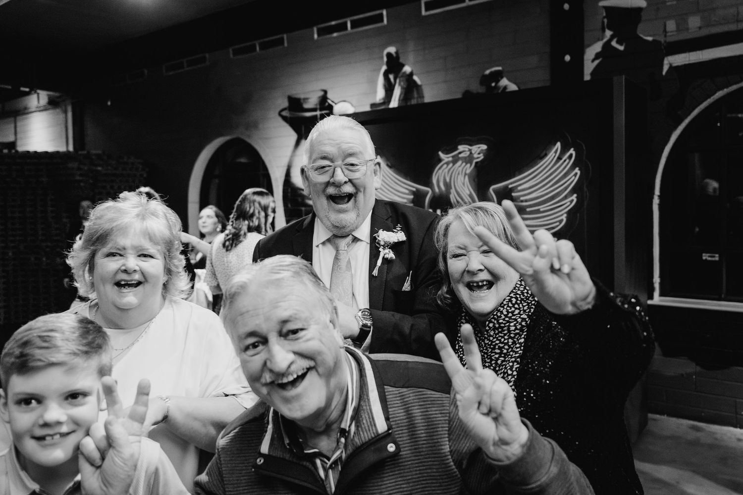 A black and white photo strip showing people laughing and expressing joy in candid moments. Wedding Photographer Dublin