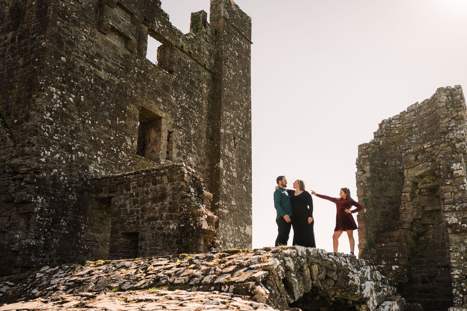 Stone castle ruins photographed at sunset with dramatic shadows and archways. Family PHOTOGRAPHER Dublin