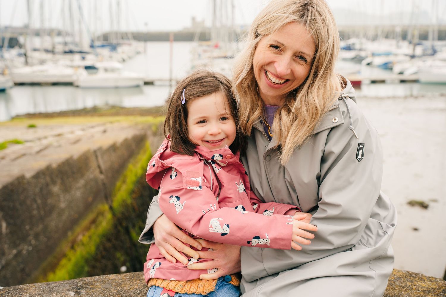 Mother and daughter share heartwarming moments together on a scenic beach during a cloudy day. PHOTOGRAPHER Dublin