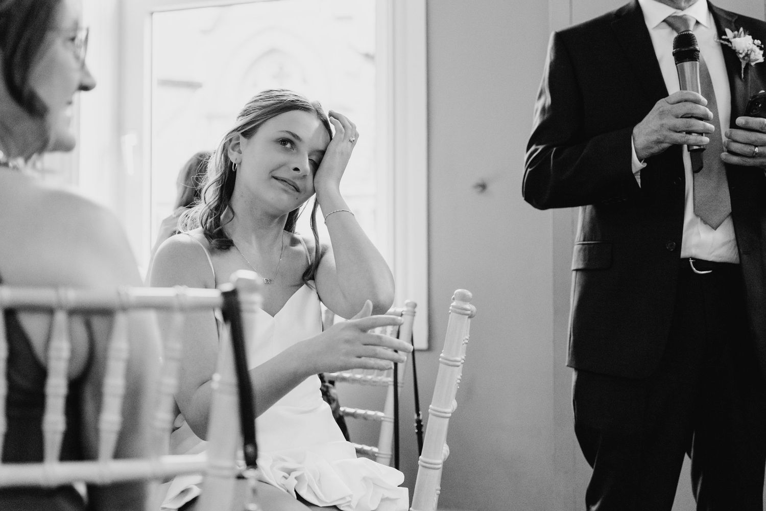 Black and white photo captures emotional moment during wedding reception speeches. PHOTOGRAPHER Dublin Ireland Wedding]