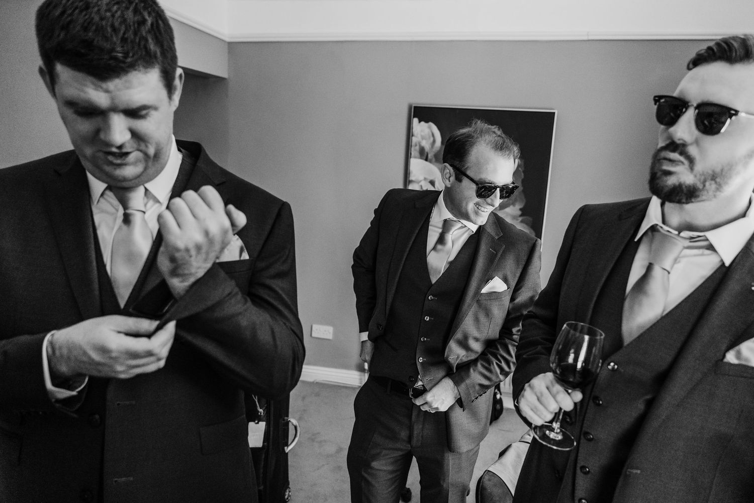 Poulaphouca Wedding photographer wicklow  Black and white photo of groomsmen getting ready and laughing together.
