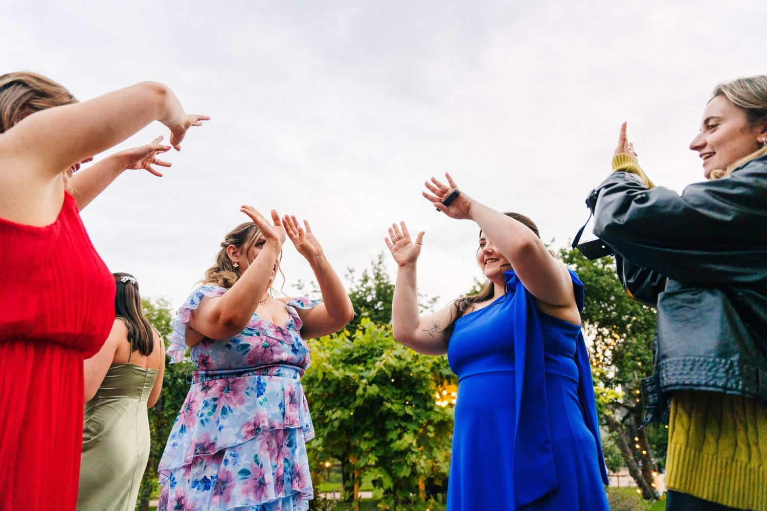 Millhouse slane wedding photographeDancing guests at a wedding reception capture a joyful moment with their hands raised on the dance floor.