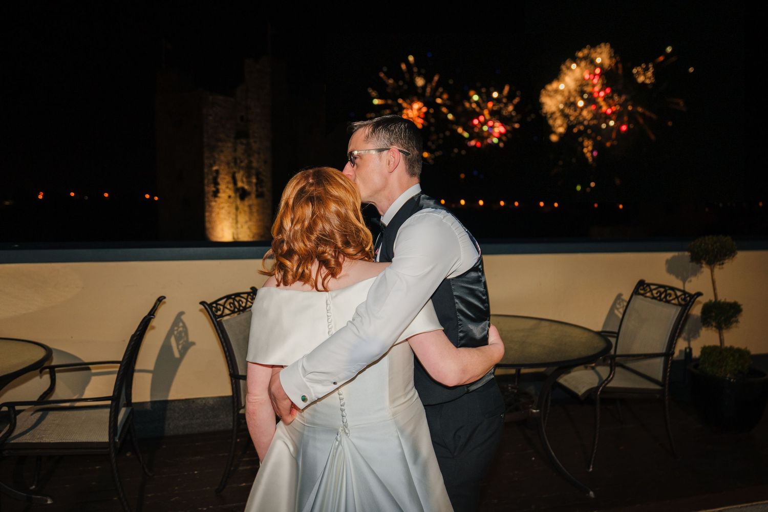 Night reception dancing scenes with string lights creating a romantic atmosphere.  Wedding PHOTOGRAPHER Trim Castle