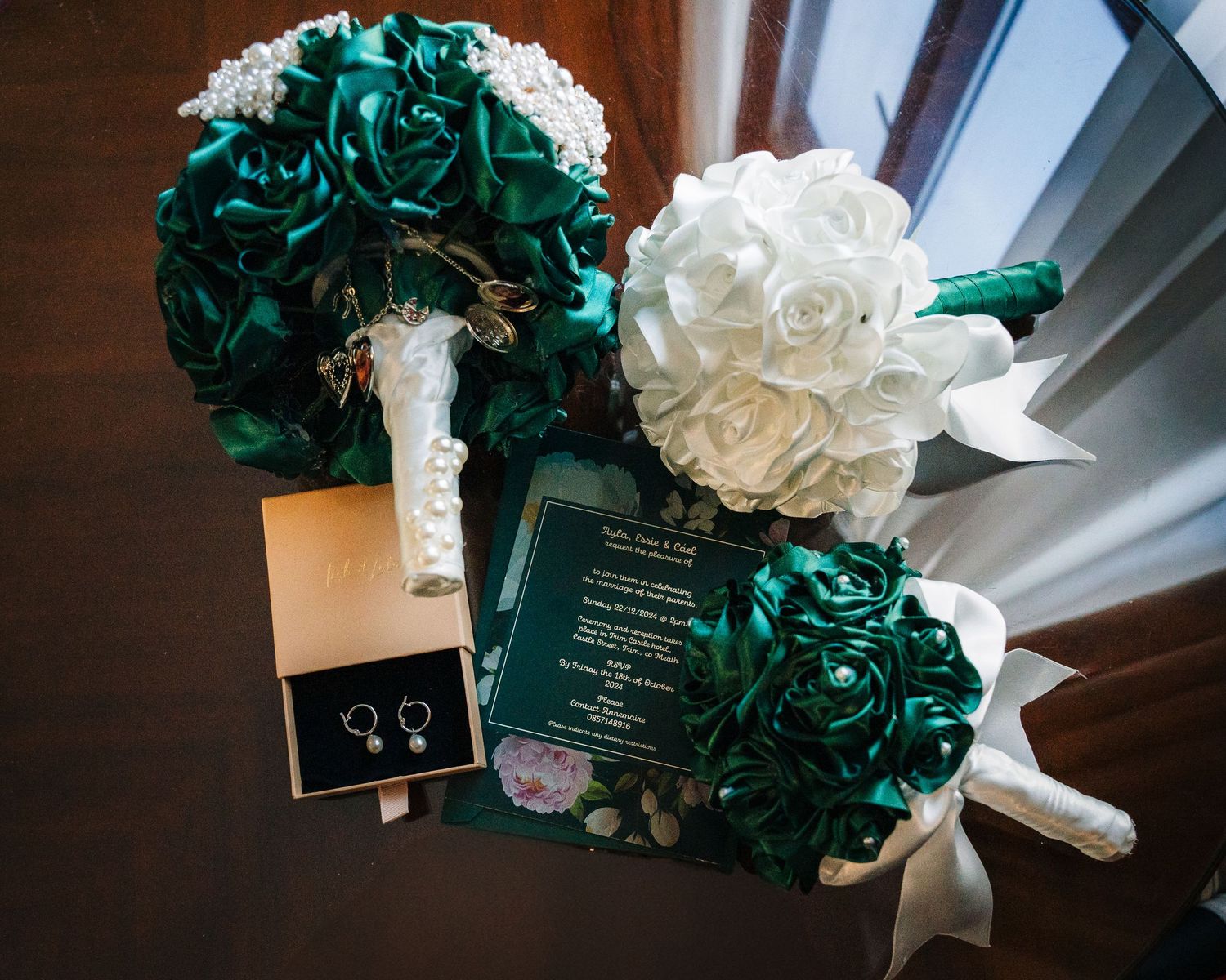 Wedding decorations featuring elegant emerald green and white floral arrangements with ribbons.  Wedding PHOTOGRAPHER Trim Castle